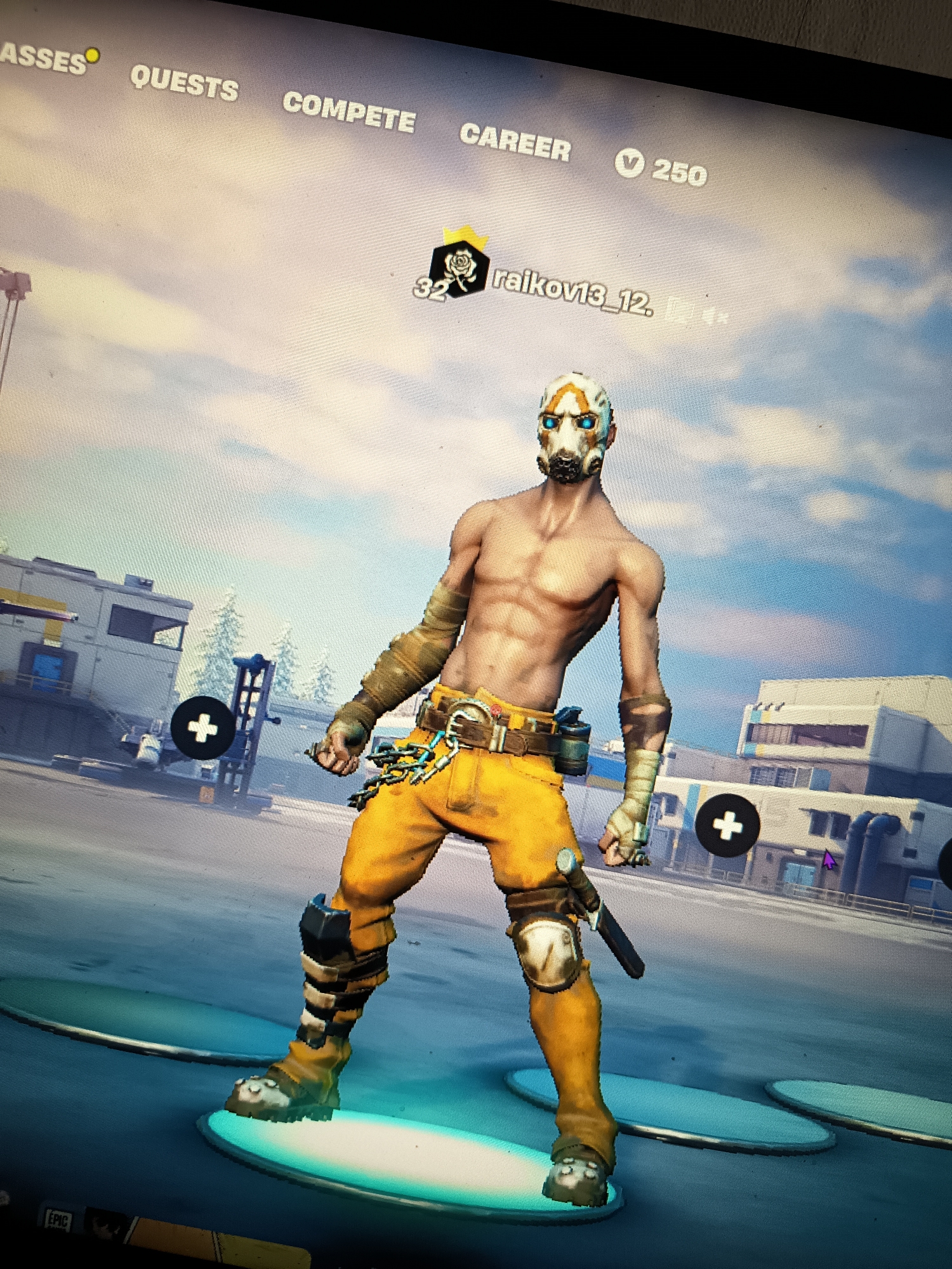 This image depicts a video game interface. In the foreground, a character with a distinctive mask and orange pants is posed on a platform. The character is shirtless, revealing a muscular physique. The background shows a digital environment resembling a city with buildings and trees under a cloudy sky. Above the character, text displays navigation options such as "CLASSES," "QUESTS," "COMPETE," and "CAREER." A username, "raikov13_12," and a level number, "32," are also visible. There is no indication of the city of Novi Iskar, Bulgaria, within the image content.