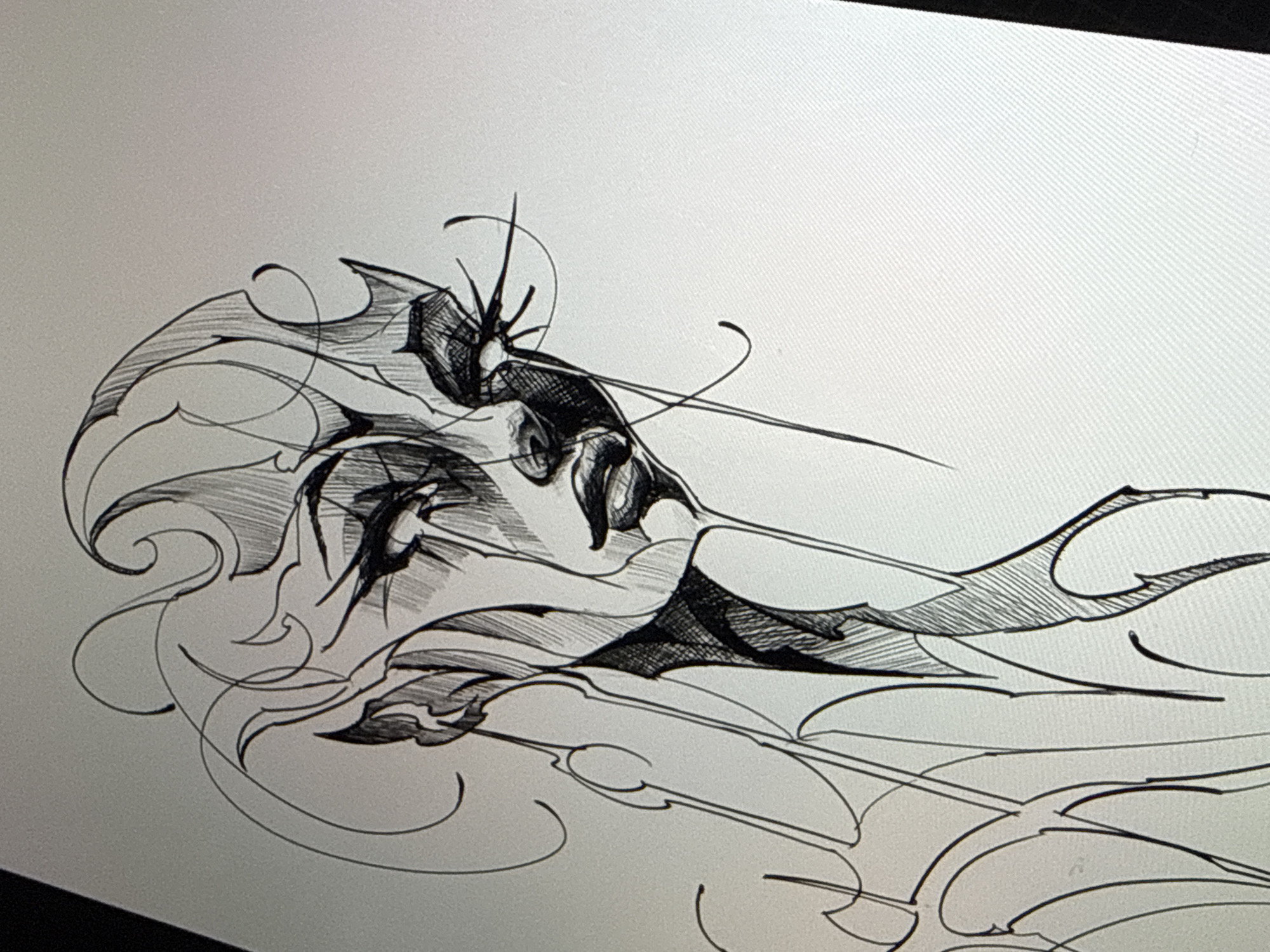 The image is a photograph of a monochrome digital drawing, displayed on what appears to be a tablet or screen, evidenced by a subtle diagonal pixel grid visible in the lighter areas. The artwork is a highly stylized, intricate line drawing executed in black ink on a light gray or white background.
The central subject is an abstract or fantastical creature, possibly resembling a moth, insect, or a dragon-like entity, rendered with a strong sense of dynamic motion. It is predominantly oriented horizontally across the frame, with a distinct head-like structure positioned towards the left. This head features prominent, sharp, spiky antennae or horns extending upwards, along with two distinct eye-like shapes.
The creature's form is composed of sweeping, organic yet angular shapes that suggest powerful wings or flowing elements. Jagged edges and pointed structures are prominent, especially on what appear to be wing-like appendages. The artist utilizes extensive cross-hatching for shading, creating depth and texture within various sections of the figure, giving it a strong three-dimensional quality. Numerous thin, flowing lines and swirling tendrils extend from the main subject and surround it, enhancing the impression of movement, speed, or an ethereal presence. These lines often curl and loop, contributing to the complex and energetic composition.
No specific environment, location cues, or discernible text are depicted within the artwork. The time of day or weather cannot be determined from the image. The drawing evokes a sense of intricate design, power, and mystery.
