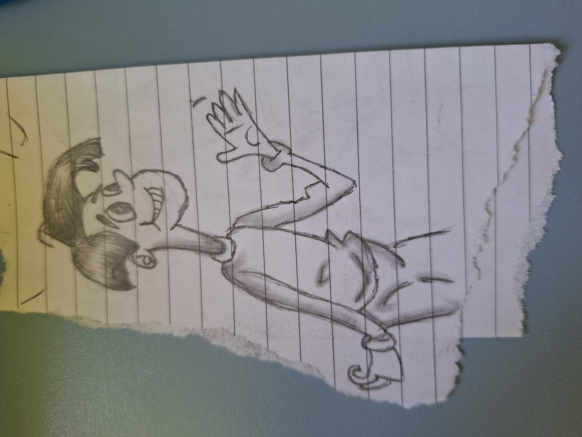 The image is a close-up, slightly angled shot of a pencil sketch on lined notebook paper. The paper is torn along the left edge and the bottom edge. The sketch depicts a cartoonish male figure with a wide smile, large eyes, and a distinctive hairstyle. The figure is wearing a long-sleeved shirt and appears to be waving or gesturing with its right hand. The sketch is in black and white and is rendered in a loose, expressive style. The background consists of a textured, light green surface. The image is not taken in Varna, Bulgaria; there is no discernible urban environment present.