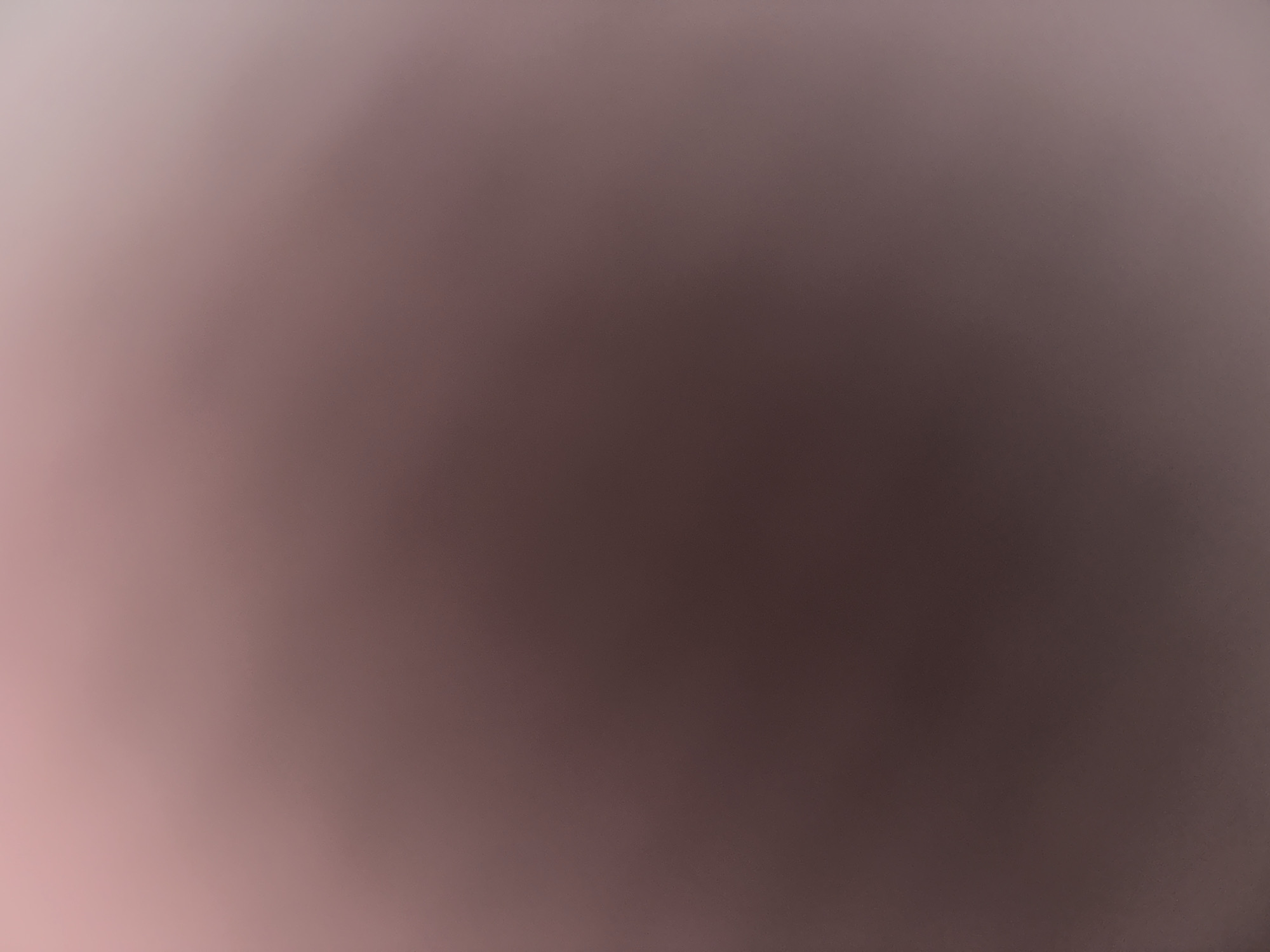 This is a digitally created abstract image that appears to be a gradient of colors. The colors transition from a light pink or white on the left side of the image to a dark brown or grey on the right side. The transition is smooth and there are no discernible subjects, objects, or scenes. There is no visible text. The image is entirely abstract and does not depict any specific activity or event. There are no location cues, time of day indicators, weather conditions, or emotional expressions visible.