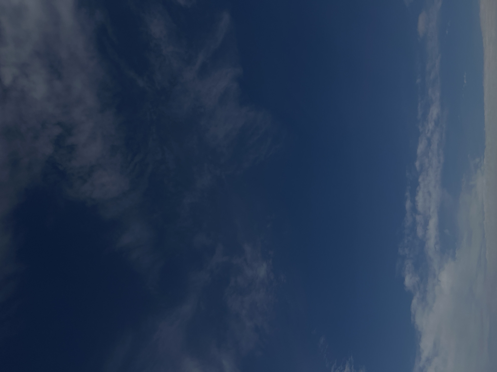 The image shows a daytime view of the sky, with a mix of clear blue areas and wispy, scattered clouds. The clouds appear thin and cirrus-like in some areas, while other areas have denser patches. The scene is typical of a clear day in the Town of Montgomery, United States of America. There are no people or objects visible in the frame other than clouds and sky.