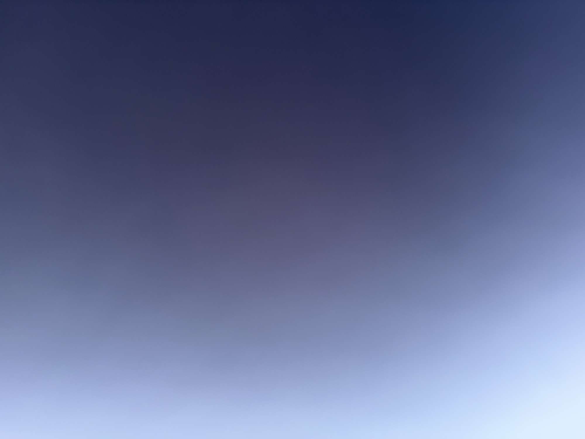 The image is a blurry, abstract photograph dominated by shades of blue and purple. There are no discernible people, subjects, objects, actions, interactions, or environmental features. The photograph appears to be a close-up shot of a surface or a gradient of light and color, lacking any specific detail that would allow for identification of a location within Elin Pelin, Bulgaria, or any other place.