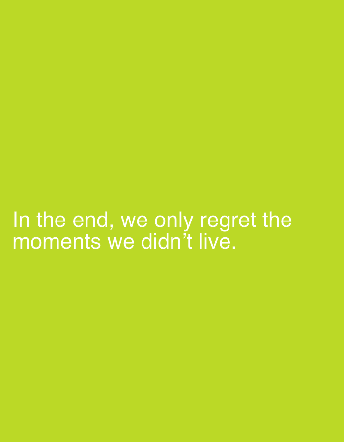 An image displays white text on a bright green background. The text reads "In the end, we only regret the moments we didn't live." The text is centered on the image and appears to be a quote. There are no other objects or people in the image. The background is a solid, uniform bright green color.