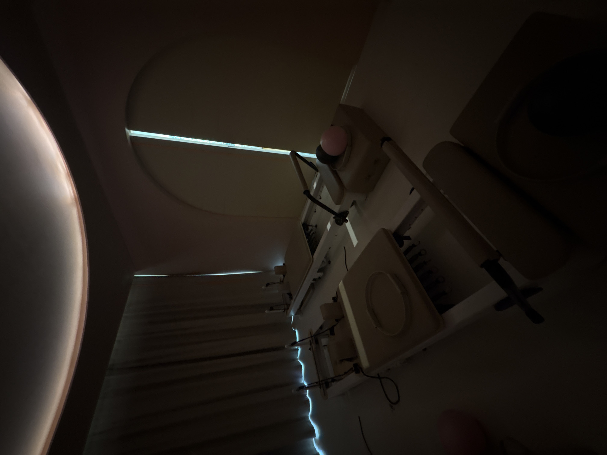 The image shows a darkened hospital room. A medical examination table with stirrups and a light fixture are visible, positioned near a window partially covered by curtains. A portion of what looks like a dome light fixture can be seen on the left of the image. Due to the lack of detail and context, I cannot determine the specific location in Mexico City.