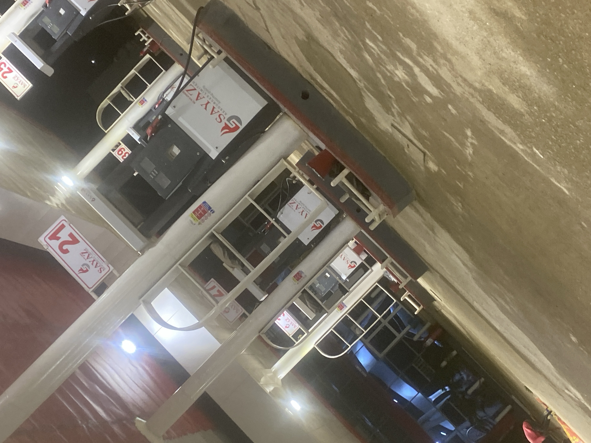 The image depicts a series of automated payment kiosks, branded with the "SAYAZ" logo and sequentially numbered (e.g., 21, 39, 25). The kiosks are likely for fueling stations or other automated services. The environment appears to be an indoor facility or an enclosed service area, though the specific details of the location in Gosa, Nigeria are not clear from the image. The perspective suggests the photo was taken at an oblique angle to the kiosks. There are no visible people or specific actions occurring in the immediate frame. The kiosks appear new and in operational condition.