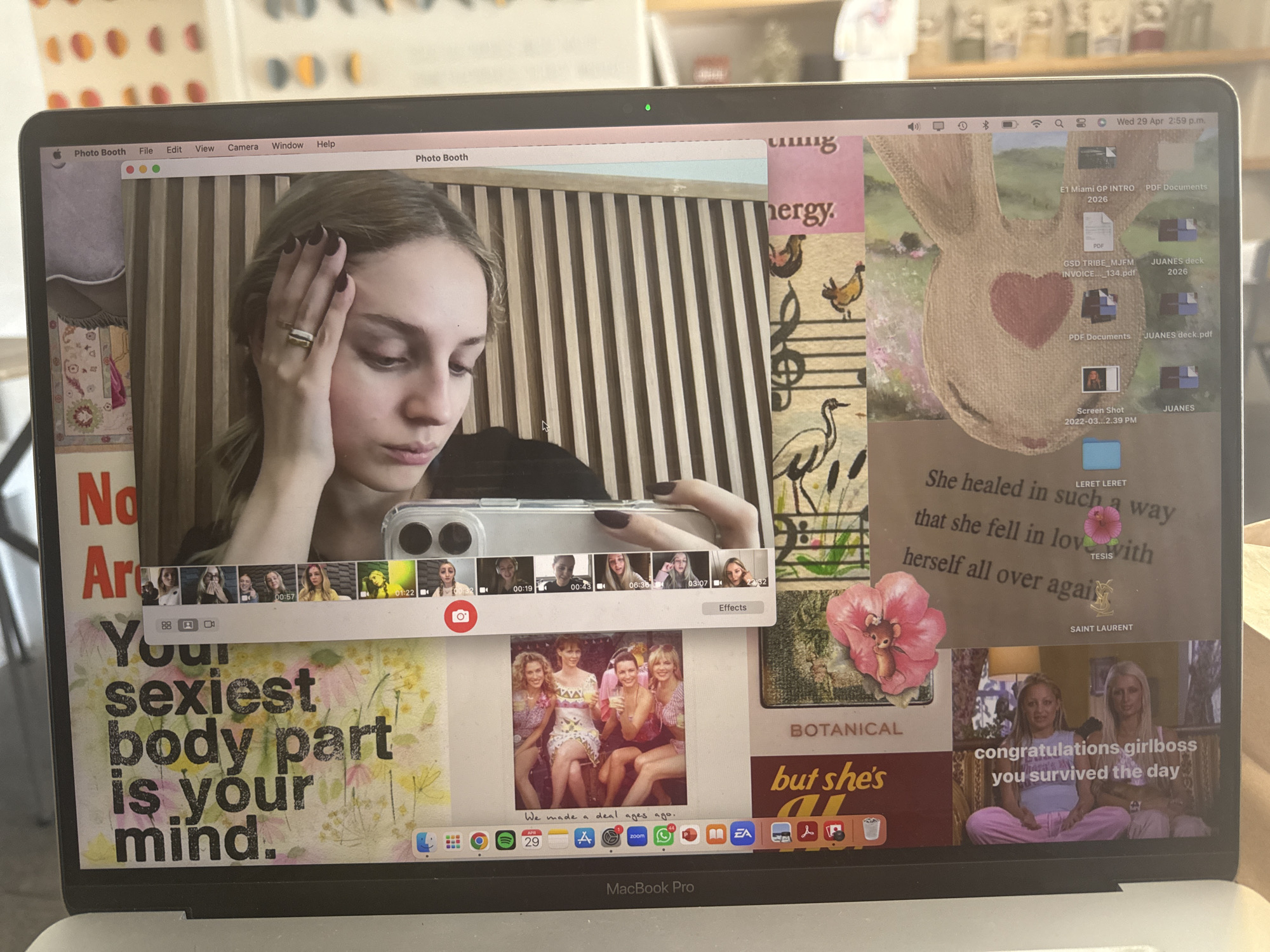 The image shows a MacBook Pro laptop displaying various content on its screen. The laptop camera is in use, showing a live feed of a person in the top center of the screen. Various images and text snippets are arranged around the live feed, creating a collage-like effect on the desktop. These include text phrases like "Your sexiest body part is your mind", and "congratulations girlboss you survived the day". There are also images of women, flowers, and other decorative elements. The top right corner shows the computer's desktop icons and system information, indicating the date and time as Wed 29 Apr 2:59 p.m. The keyboard and trackpad of the MacBook Pro are visible at the bottom.
The location in the city of Mexico City, Mexico is not apparent from the image.