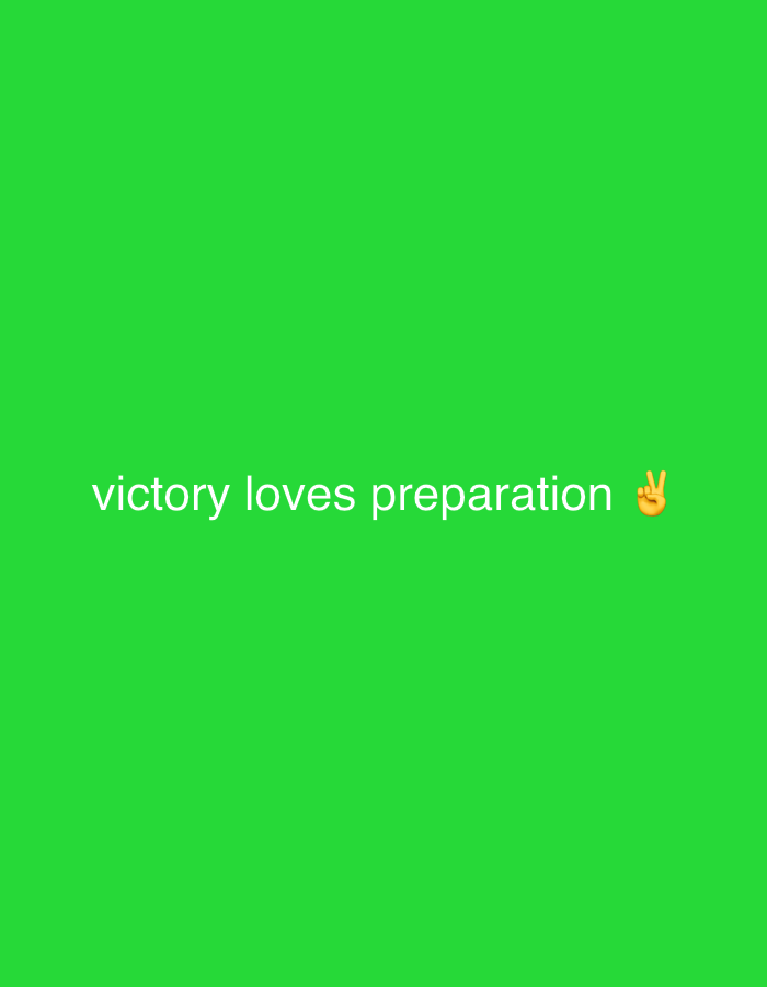 The image displays a bright green background with white text that reads "victory loves preparation" on the lower half of the screen. To the right of the text, there is a peach-colored emoji of a hand making the peace sign. The image is centrally focused, with no visible surroundings or environmental context that would indicate a specific location in Wai A, Nigeria.