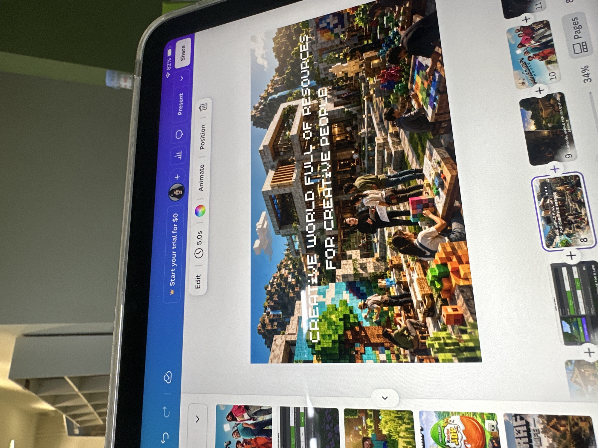 The image shows a screen display of a Canva project on a tablet device. The project is a presentation featuring various slides, with a central slide showcasing a Minecraft-themed image. This image depicts a complex Minecraft landscape, possibly a virtual city, with structures and figures resembling real-life people interacting within it. The text "CREATIVE WORLD FULL OF RESOURCES FOR CREATIVE PEOPLE" is overlaid on the image. Additional slides of the presentation are visible in a panel on the right side of the screen and at the bottom, showing different photos and graphics. The Canva user interface is also visible, displaying options for editing, animation, positioning, and presentation.