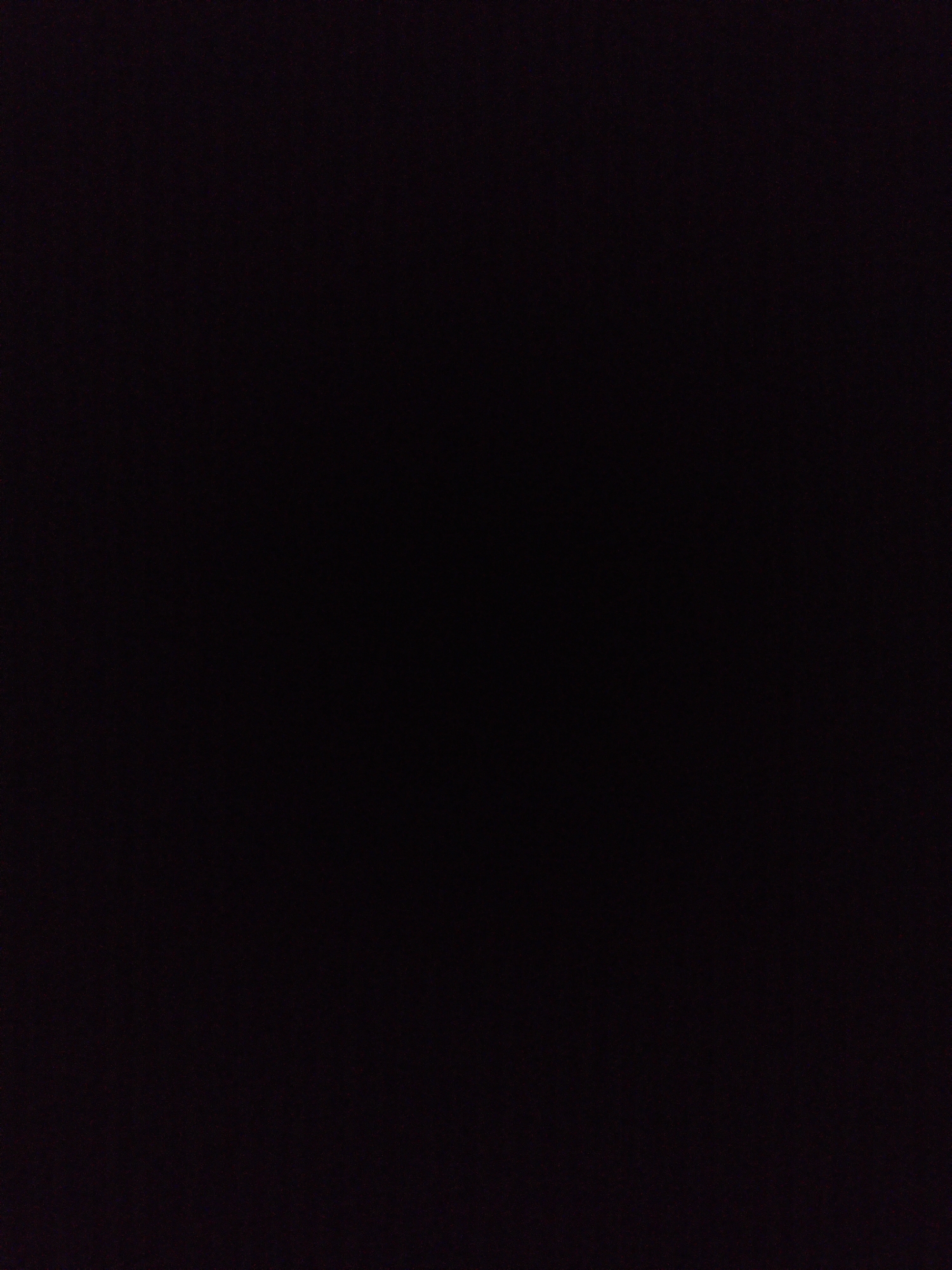 The image is almost entirely black, making it impossible to discern any specific subjects, objects, or a distinct scene. The profound darkness suggests it was captured in extremely low light conditions, such as at night or in a completely unlit indoor environment. No activity, events, or emotions are visible or implied. There is no visible text within the frame. While the location context of Ustyvytsia, Ukraine, is provided, the image itself offers no visual cues to confirm or illustrate this specific setting. The dominant feature of the media file is its near-absolute blackness, with only subtle, barely perceptible variations in tone and a faint grain or texture across the frame, indicating it is a photographic capture rather than a solid color block.