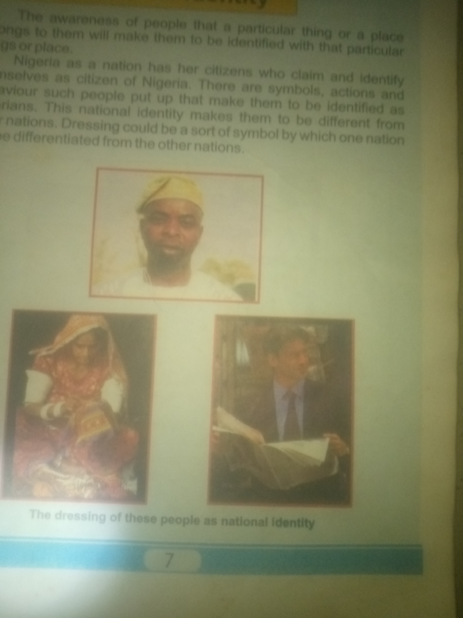 The image shows a page from a book or document. The text discusses national identity, mentioning Nigeria and its citizens. Below the text are three framed images. The top image is a portrait of a man wearing a yellow cap and white clothing. The bottom left image shows a woman dressed in traditional attire, possibly Indian, with bangles on her wrists. The bottom right image shows a man in a suit and tie, holding a newspaper. The text below the images reads, "The dressing of these people as national identity." There is also a page number "7" visible at the bottom. There is no information about the city of Jauro Yinu, Nigeria in this image.