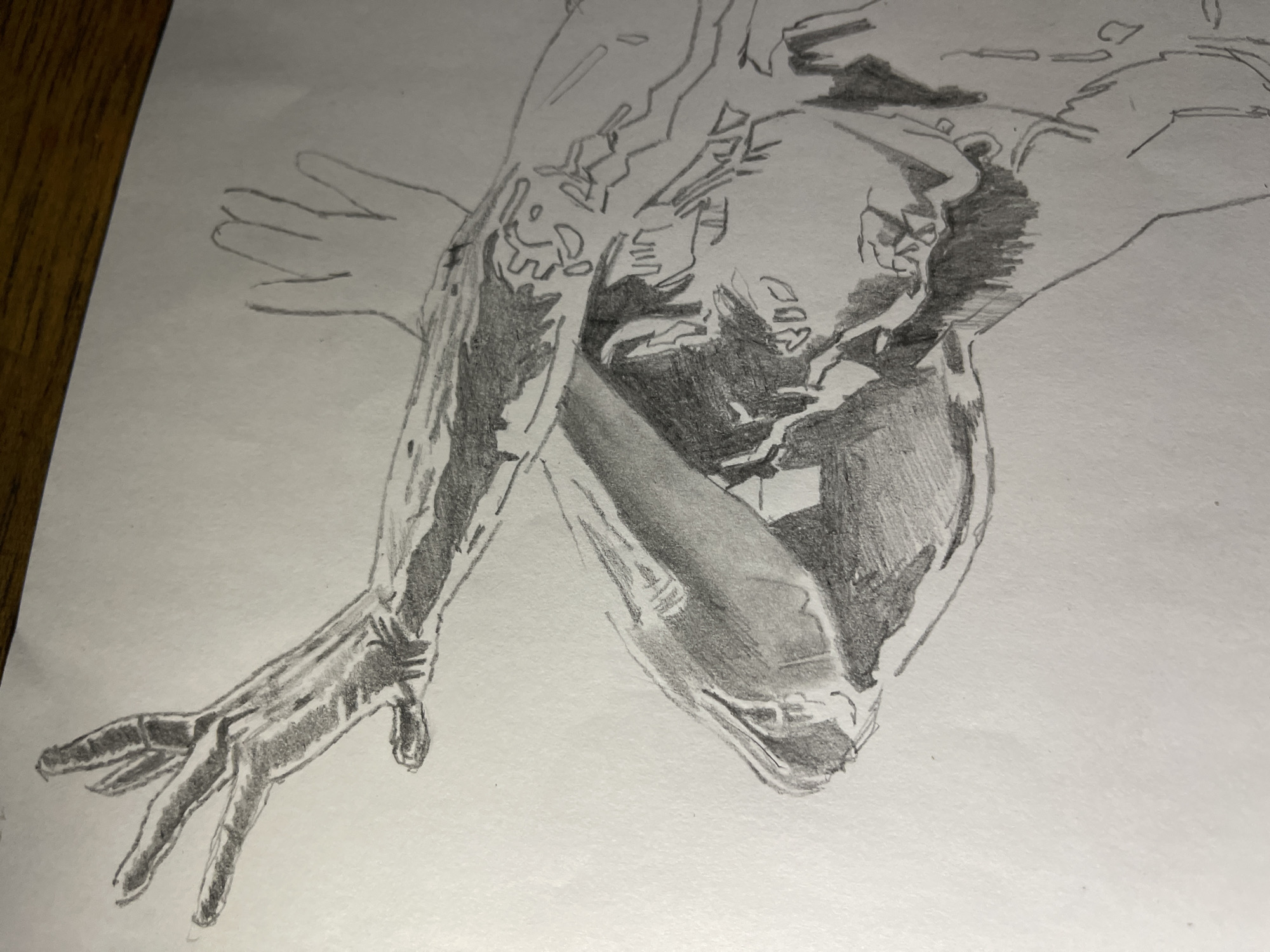 The image is a pencil drawing of a human figure in a contorted pose. The figure's head is turned downwards, obscuring the face. The arms are crossed, and the hands are visible, one reaching out with fingers slightly splayed. The shading indicates a light source from above, creating strong contrasts between light and shadow. The style is realistic with attention to musculature and form. There are some lines and patterns that could suggest tattoos or design elements on the body.
There is no indication in the image that it is set in Jos, Nigeria, or any specific city. The environment is not depicted; only the figure is present.