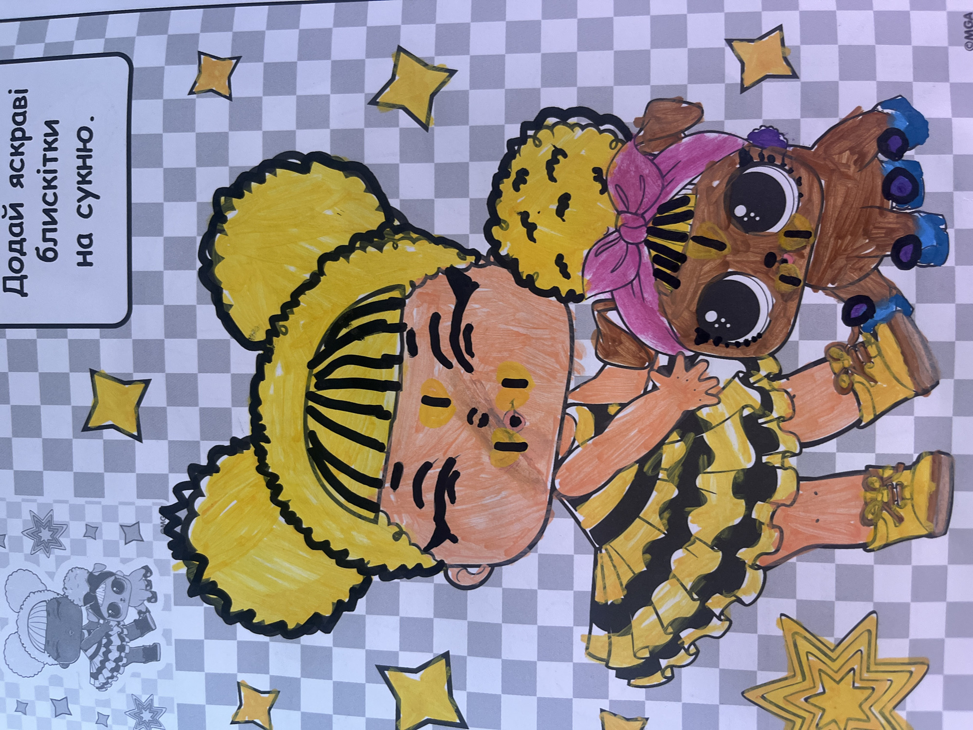 The image depicts a coloring page with a drawing of two stylized doll characters and a small dog-like creature, rendered in crayon. One doll, with large yellow curly hair and a black and yellow striped dress, stands on the left. The other character, a small brown creature with a pink bow on its head, sits to the right of the doll. The background features a gray and white checkerboard pattern and several yellow stars. Text in Ukrainian is present in the upper right corner, which translates to "Add bright glitter to the dress." The image is a close-up shot and does not contain any identifiable geographical landmarks or elements that would allow for a determination of its location in Tarnivtsi, Ukraine, or any other city. The scene is static, showing only the drawing itself.