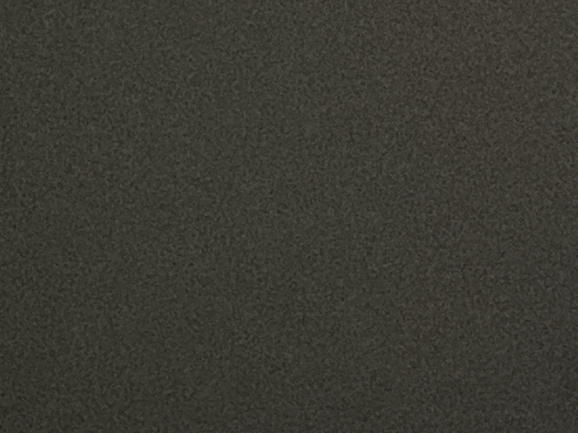 The image is a close-up, top-down view of a textured, dark grey surface. The texture appears granular or slightly rough, with subtle variations in shade that create a speckled or mottled appearance. There are no visible objects, people, or any distinguishing features within the frame. The lighting is even, and there are no shadows. The image is likely a photograph of a material surface, such as concrete, asphalt, or a similar rough-textured substance. There is no contextual information provided that would associate this image with Grigorevo, Bulgaria.