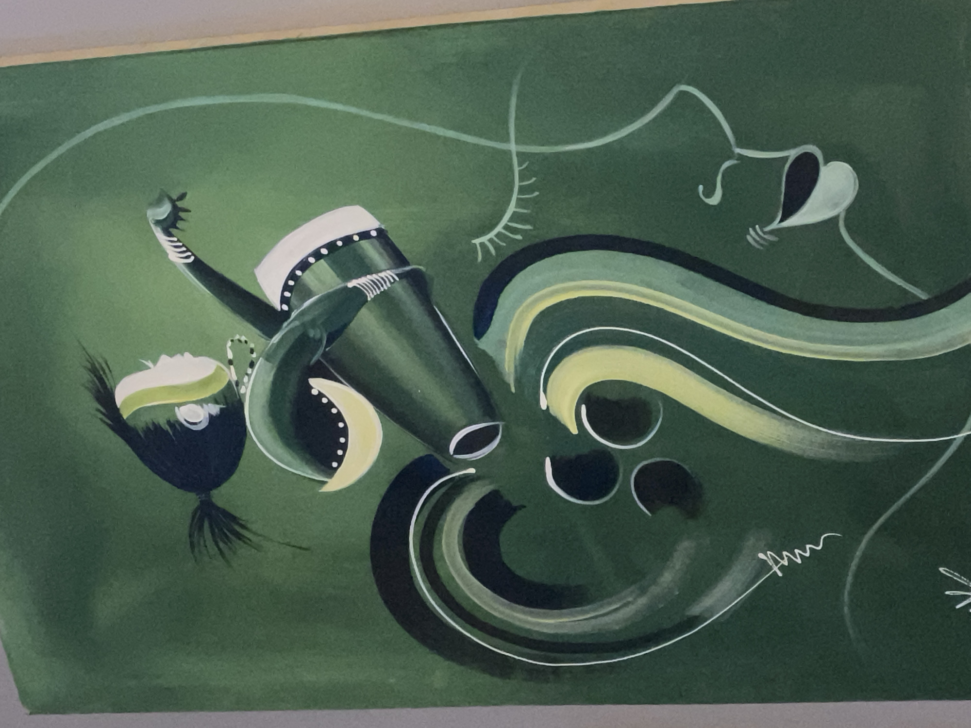 This is a painting with a green background. The painting features a stylized figure of a person with dark hair, green and yellow clothing, and white accents. The figure appears to be in motion, with one arm extended. To the right of the figure, a profile of a face is outlined in white, with closed eyes and an open mouth. Swirling lines in green, dark blue, and white, along with circular shapes, are incorporated into the composition around the figure and the face. The painting is framed by a light-colored border. No specific location in Kurunduma, Nigeria, is depicted or indicated in this artwork.