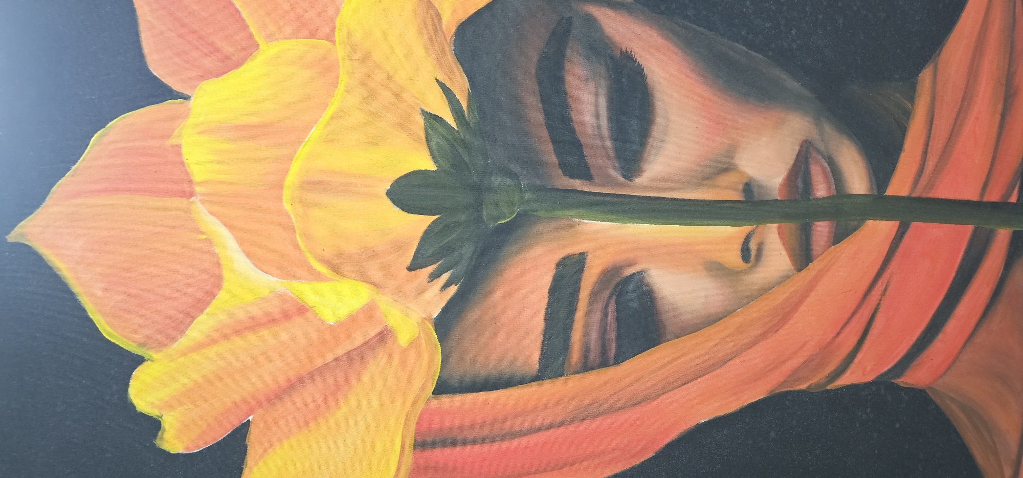 The image depicts a painting. In the foreground, a large, orange and yellow flower is prominently displayed, with its stem extending across the canvas. Behind the flower, a woman's face is visible, with her eyes closed, her skin appearing peachy, and her lips a soft red. She wears an orange head covering. The background is a dark, indistinct color. There is no information to suggest the image's location as Denpasar, Indonesia.
