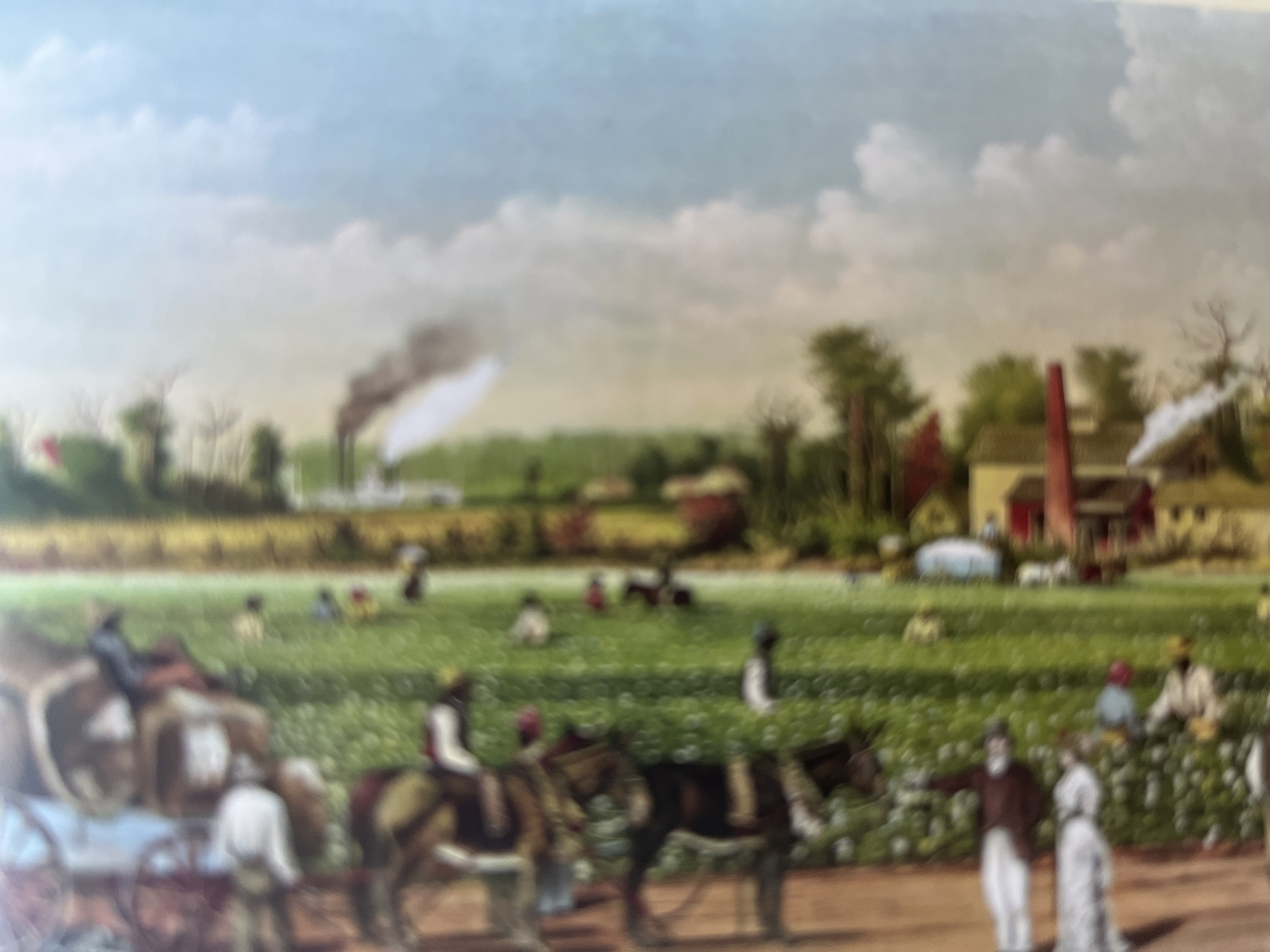 A slightly blurry, vertically oriented, close-up photograph depicts a painting of a rural scene. The painting features a team of horses pulling a cart laden with sacks, with people dressed in historical attire standing near them. The horses and cart are positioned on the left side of the image. A green field extends to the right, dotted with trees and a building. The sky above is filled with clouds. The overall impression is that of a pastoral landscape, possibly depicting a harvest or agricultural activity.