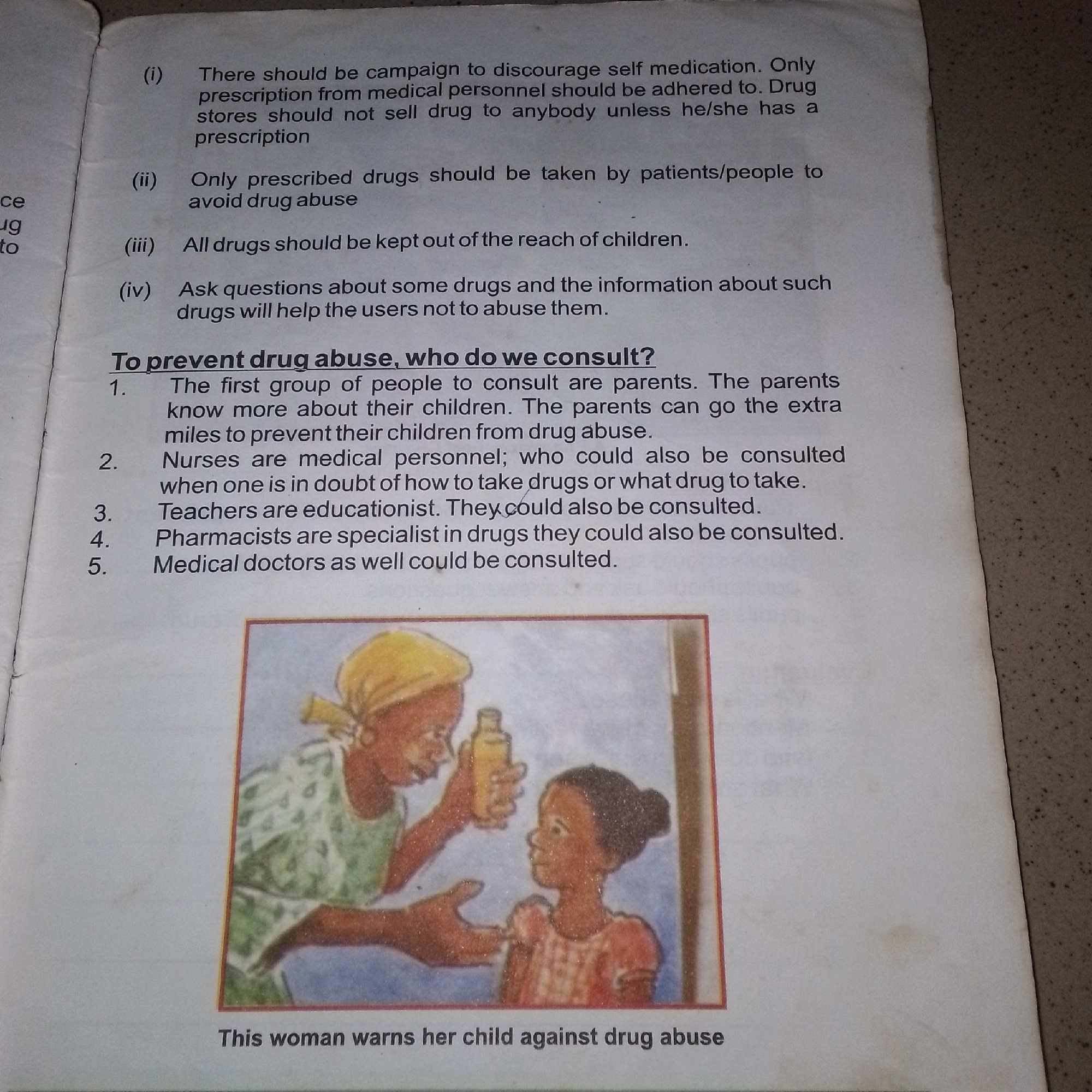 The image contains a page of text and an illustration. The text lists points related to preventing drug abuse. The illustration depicts a woman holding a bottle and offering it to a child, with the caption "This woman warns her child against drug abuse." The text and illustration do not provide any information about the city of Jalingo, Nigeria.