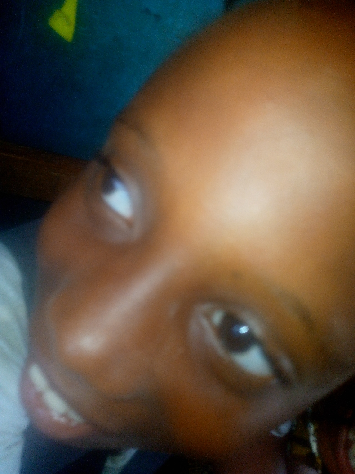 Close-up of a child's face. No location can be determined from this image.