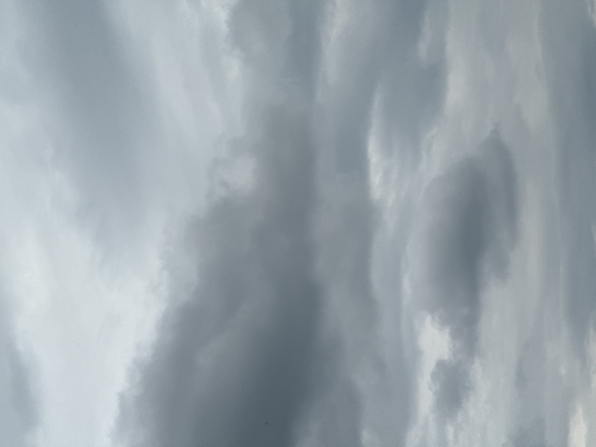 The image shows a section of the sky filled with gray and white clouds. The clouds appear dense and layered, indicative of an overcast or stormy weather pattern. The location is Stone Mountain, United States of America.
