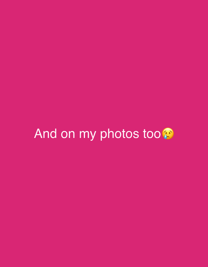 The image consists of the text "And on my photos too" with a slightly tearful face emoji at the end, set against a solid pink background. There are no people, subjects, objects, or interactions visible. The environment is a flat, uniform color. There is no indication of the location being Chaikovsky, Russia, or any other specific place.
