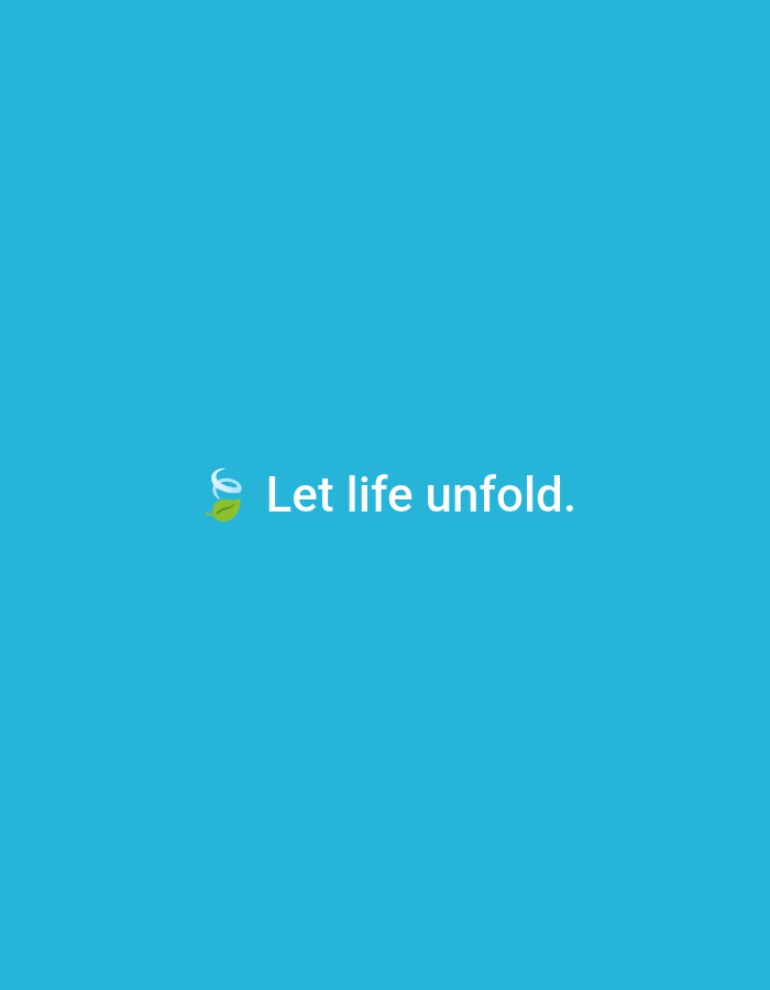 The image displays a solid sky blue background. Centered horizontally and slightly below the vertical midline of the frame is the phrase "Let life unfold." rendered in white, sans-serif lettering. To the immediate left of the text, a small logo is visible, consisting of a white, stylized swirl or spiral originating from a single green leaf. No people, additional subjects, objects, or specific environmental details are depicted. There is no visual information within the image to indicate a location in the city of Casablanca, Morocco, or any other geographical area.