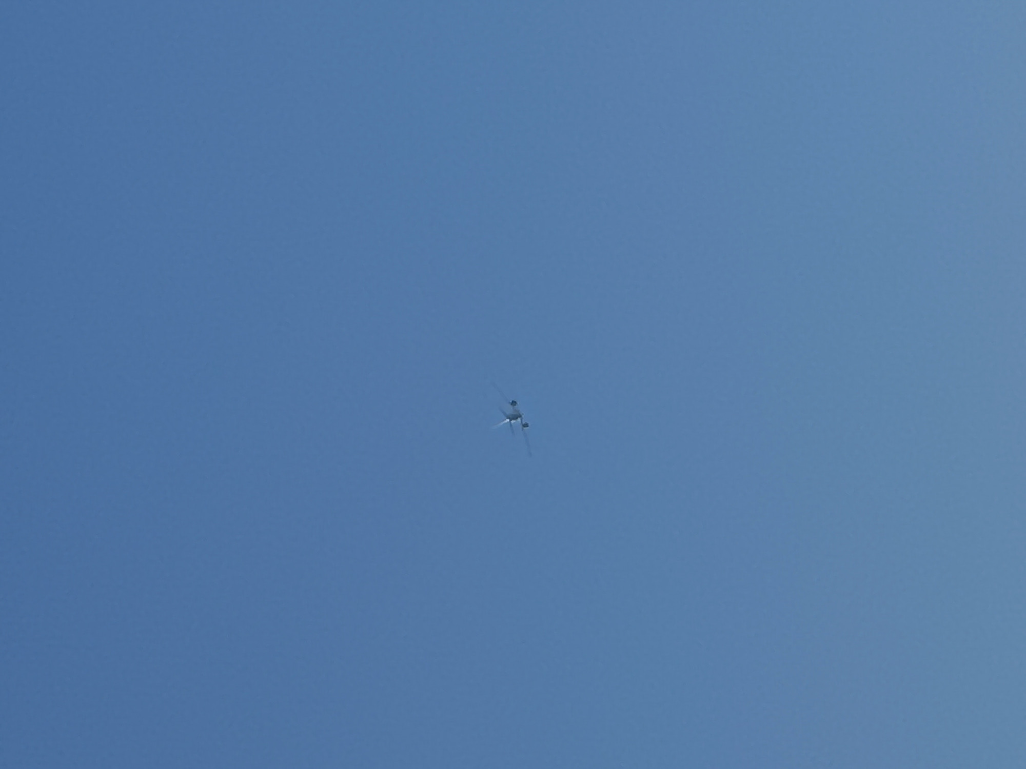 An airplane is visible in the sky. The airplane is white and appears to be in flight. It is a clear, blue sky with no clouds. The image does not provide enough information to determine the specific location in Varna, Bulgaria.
