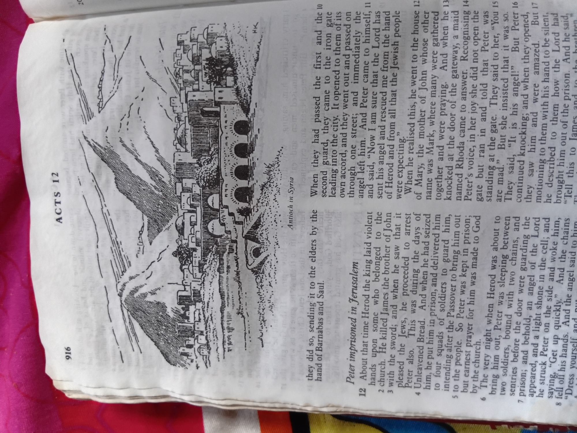 This media file displays a page from a book, likely a Bible, featuring an illustration and text. The illustration depicts a city with buildings, a bridge with multiple arches, and a mountainous landscape in the background. The text is printed in columns and includes a chapter heading, "ACTS 12," and page number "916." There are also smaller, possibly commentary notes, like "Antioch in Syria." The text discusses the imprisonment of Peter and his miraculous escape from prison. The event described is Peter's deliverance from prison, guided by an angel, and his subsequent arrival at the house of Mary. The text implies a nighttime setting for Peter's escape, with details about chains, guards, and a shining light from an angel. The emotions conveyed through the text are fear, expectation, and amazement. The location cues point to Jerusalem for the imprisonment and a house belonging to Mary in an unspecified location for his arrival. The visible text also includes chapter and verse numbers, suggesting a narrative biblical account.