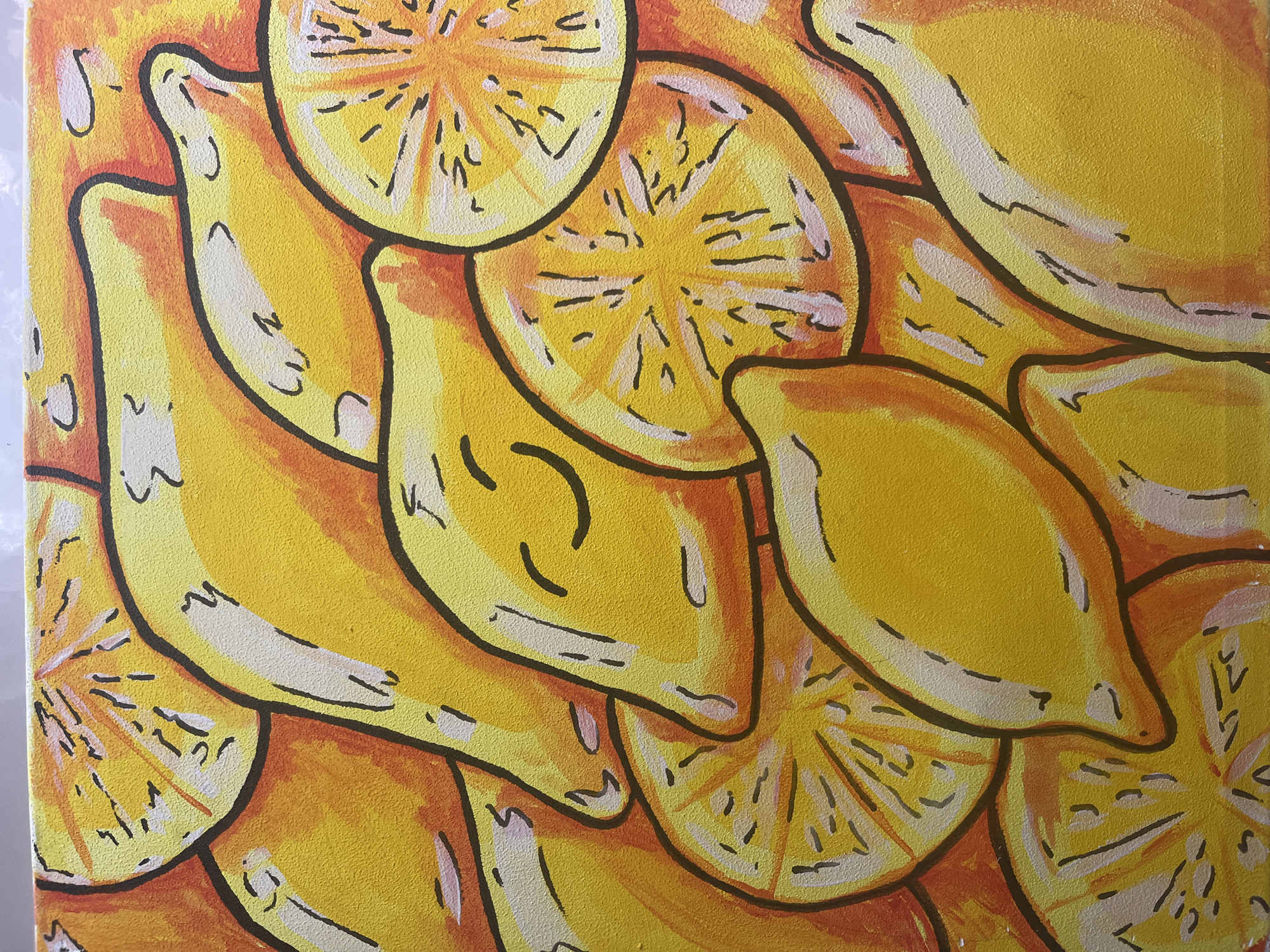 This is a close-up, overhead shot of a painting depicting numerous sliced lemons and whole lemons. The artwork is vibrant, with a dominant palette of yellows and oranges, accented by thick black outlines. Some of the sliced lemons reveal detailed internal patterns suggesting segments and pulp. One whole lemon appears to have a simple, drawn-on smiley face. The background is an abstract wash of orange and yellow hues. The texture of the canvas is visible throughout the image. There is no discernible city, location, or environmental context within the frame of the painting itself.