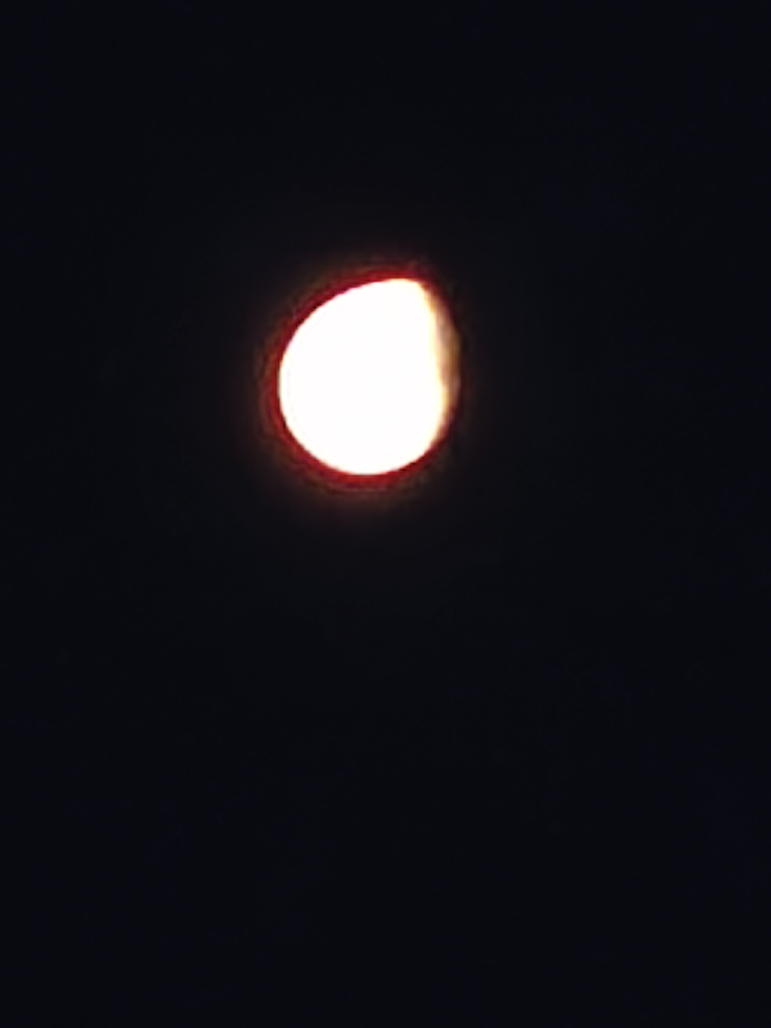 The image shows a half moon in a dark sky. There are no visible details indicating the location is Burgas, Bulgaria, or any information about people, subjects, objects, actions, or interactions.
