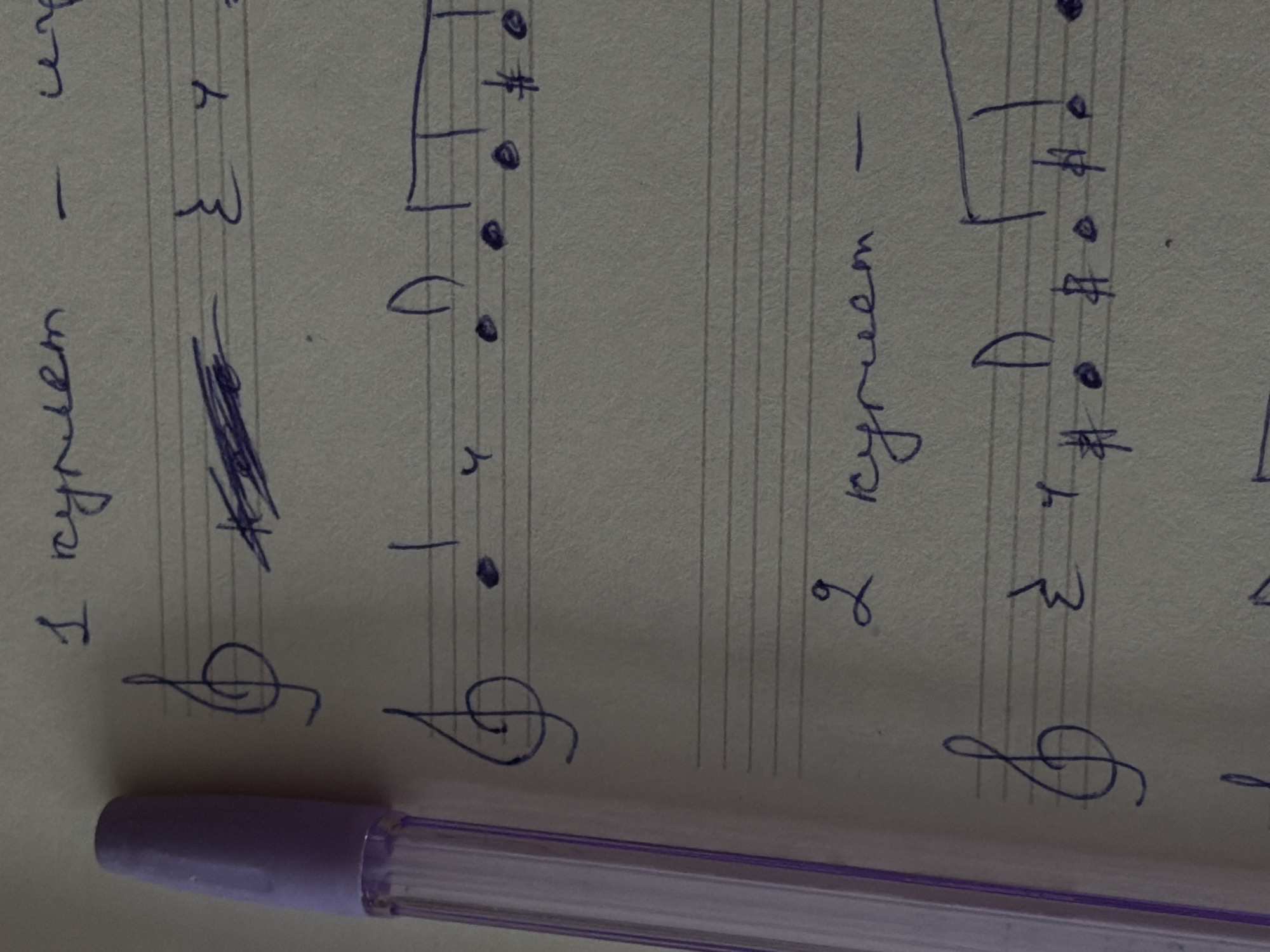 The image shows a handwritten musical score on lined paper. The score includes treble clefs, notes, and rests, as well as handwritten text in what appears to be Russian. A transparent purple pen rests along the bottom edge of the paper. There is no visual evidence to place this scene in Perm, Russia, or any other specific location.