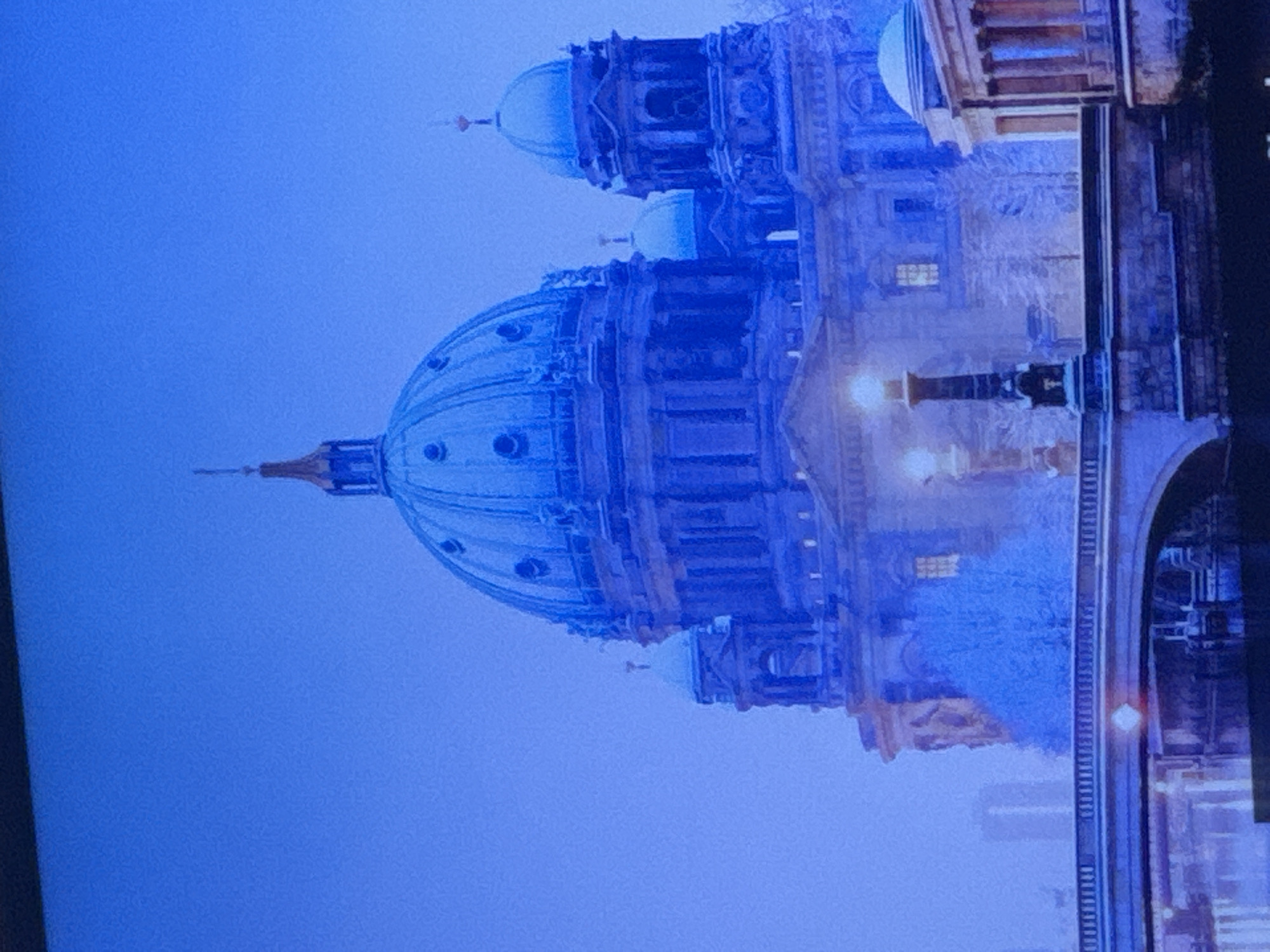 The image shows the Berlin Cathedral (Berliner Dom) in Berlin, Germany. The photo appears to be taken on a foggy day or possibly in the evening, given the muted light and visible building lights. The architectural details of the cathedral are prominent, including the domes, columns, and statues. There is no evidence of any location in the city of Puebla, Mexico in the image.