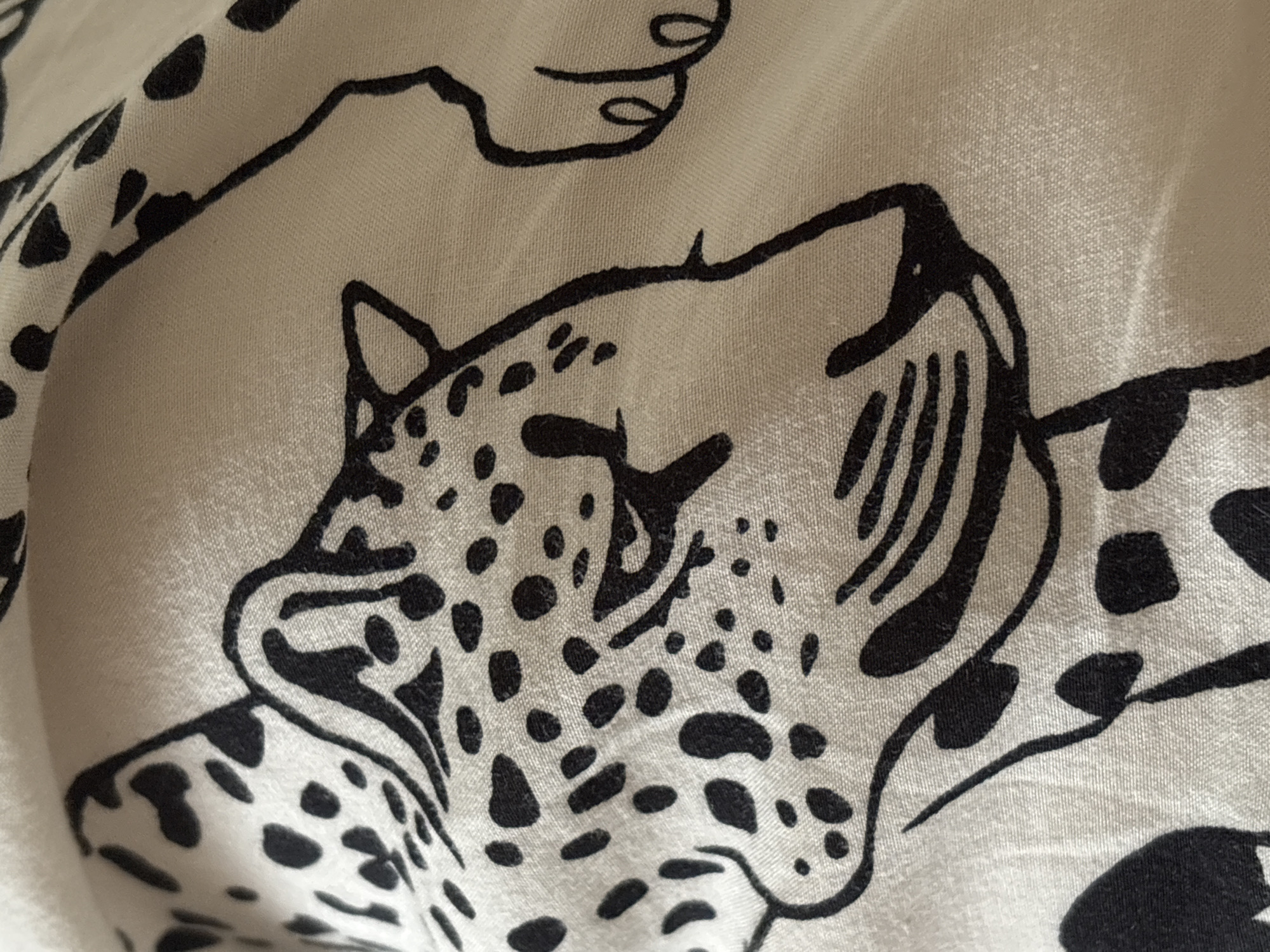 The image shows a close-up of a fabric with a black and white leopard print pattern. The print features the head and spots of a leopard. There is no indication of the city of Tikhiye Zori, Russia, in the image.