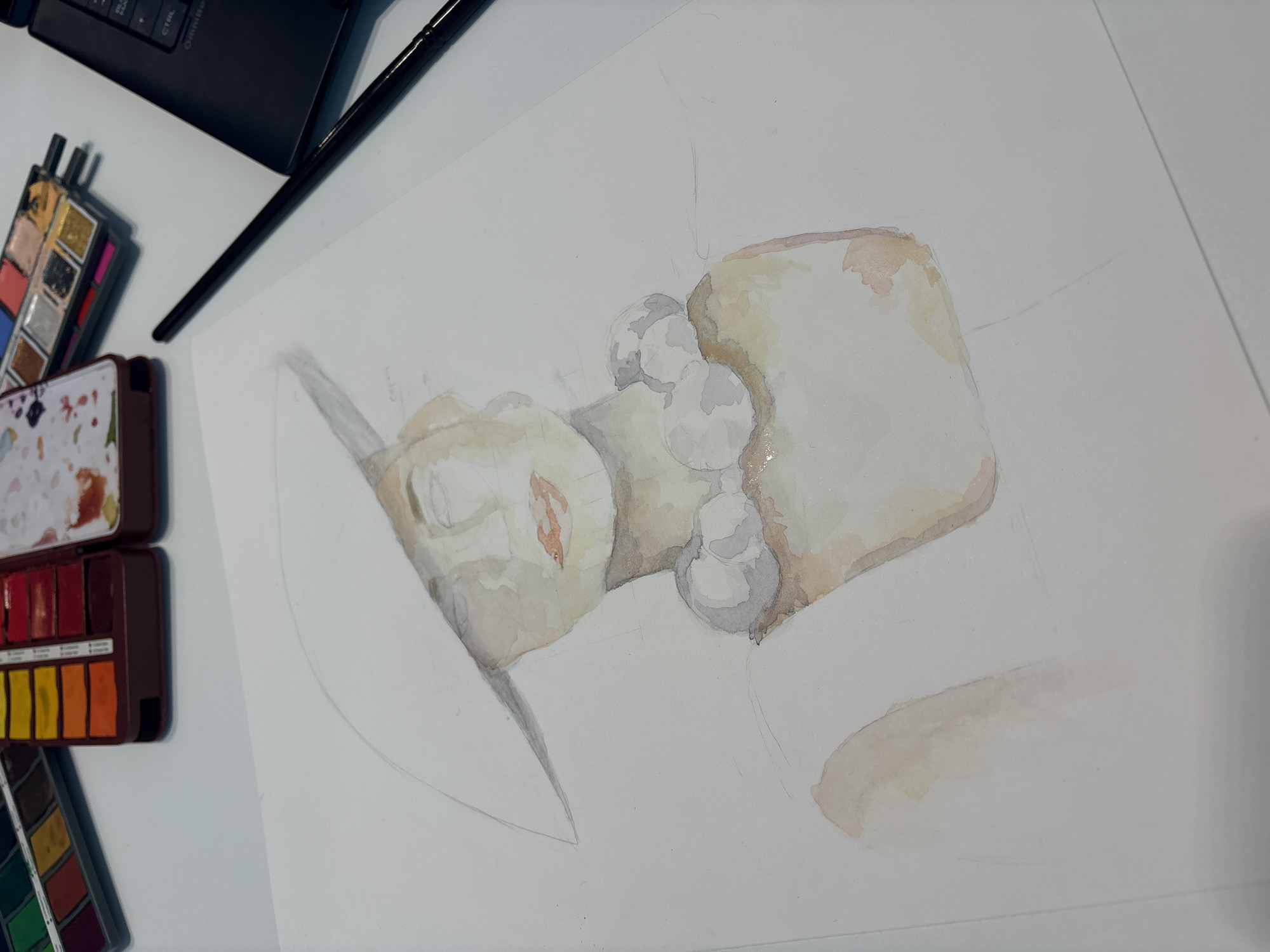 The image shows a watercolor painting in progress of a sculpture. The sculpture is possibly made of white marble, with hints of pink and gray watercolor shading, sitting on a plinth. The style depicts an unfinished artwork with pencil under-drawing visible. It is unclear what or who the sculpture is depicting.
On the left side of the painting are watercolor palettes, a brush, and a partially visible laptop. The paper is a large white sheet and appears to be on a desk.