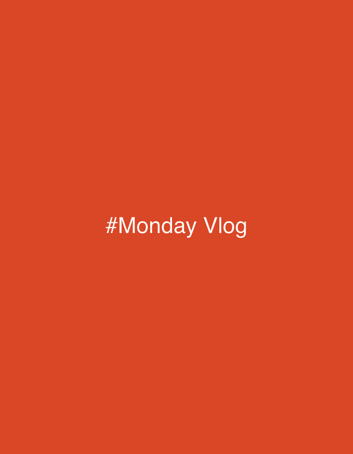The image shows white text on an orange background. The text reads "#Monday Vlog". There is no indication of the city of Kazan, Russia.