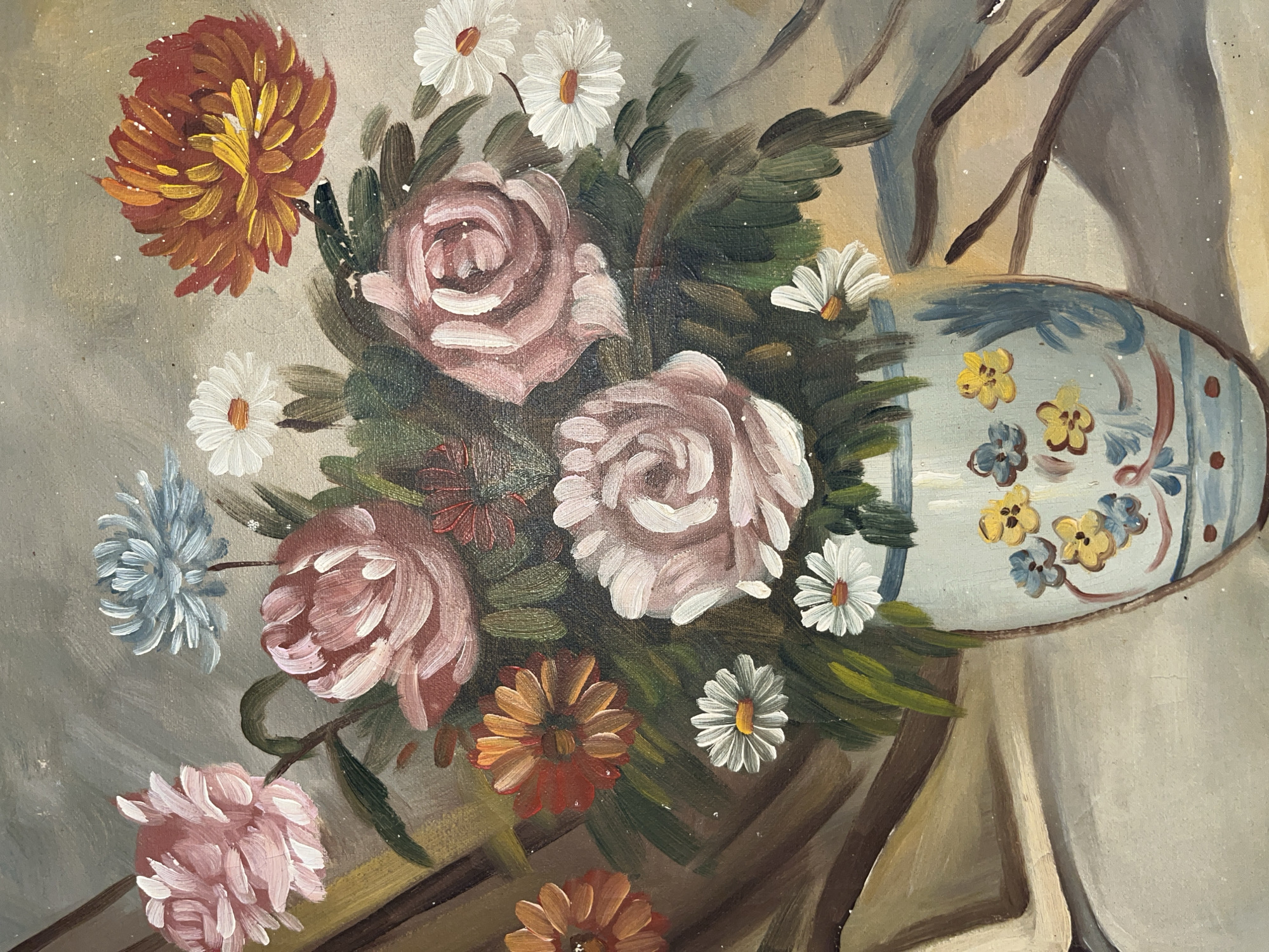 A still life painting shows a bouquet of flowers in a light blue and white vase. The flowers are of various types and colors, including pink roses, white daisies, orange and brown chrysanthemums, and a blue flower. The vase is decorated with yellow and blue flowers. The background is a neutral grey color, and the scene appears to be indoors. The location in Tinaquillo, Venezuela is not discernible from the visual elements of the image.