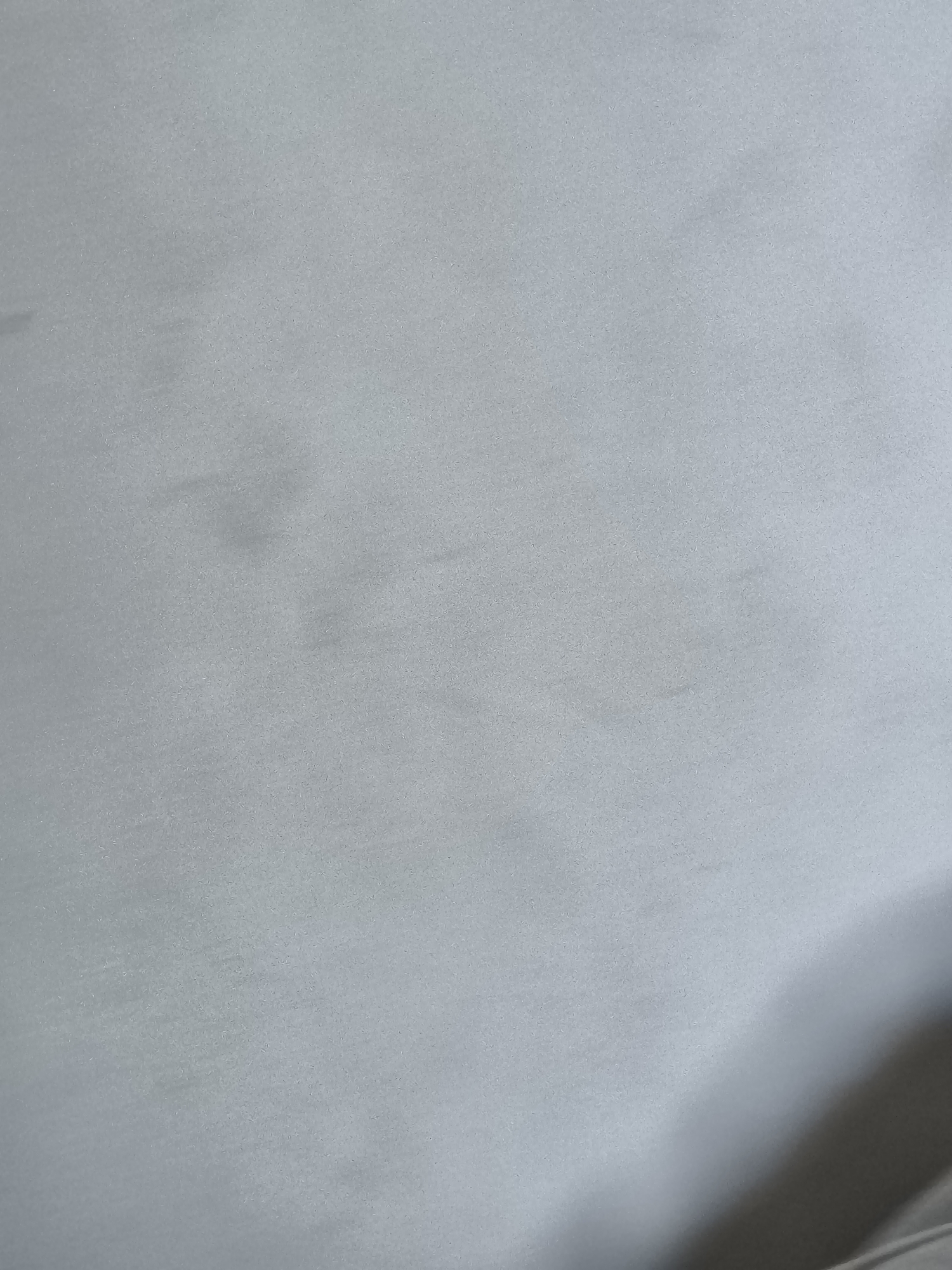The image shows a close-up of a silver-grey surface. There is no discernable location in Pélussin, France, people, subjects, objects, actions, interactions, or environment. The image is essentially an abstract, textured grey field.