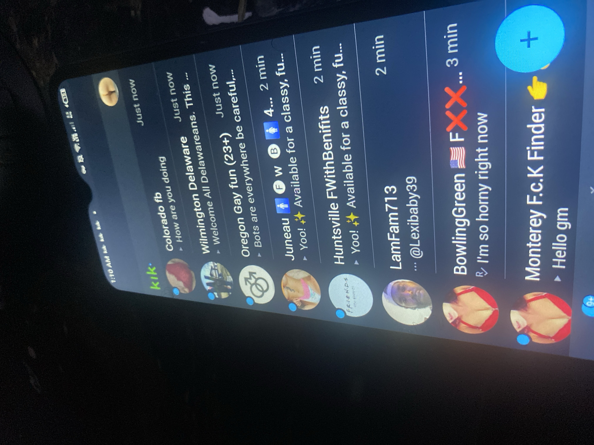 The image shows a cell phone screen displaying the Kik messaging app. The screen displays several conversations with users, including "Colorado fb," "Wilmington Delaware," "Oregon Gay fun," "Juneau," "Huntsville FWithBenifits," "LamFam713," "BowlingGreen," and "Monterey F.c.K Finder." Several messages are sexually explicit. The time displayed on the phone is 1:10 AM. There is no visible information related to the city of Bukuru, Nigeria.