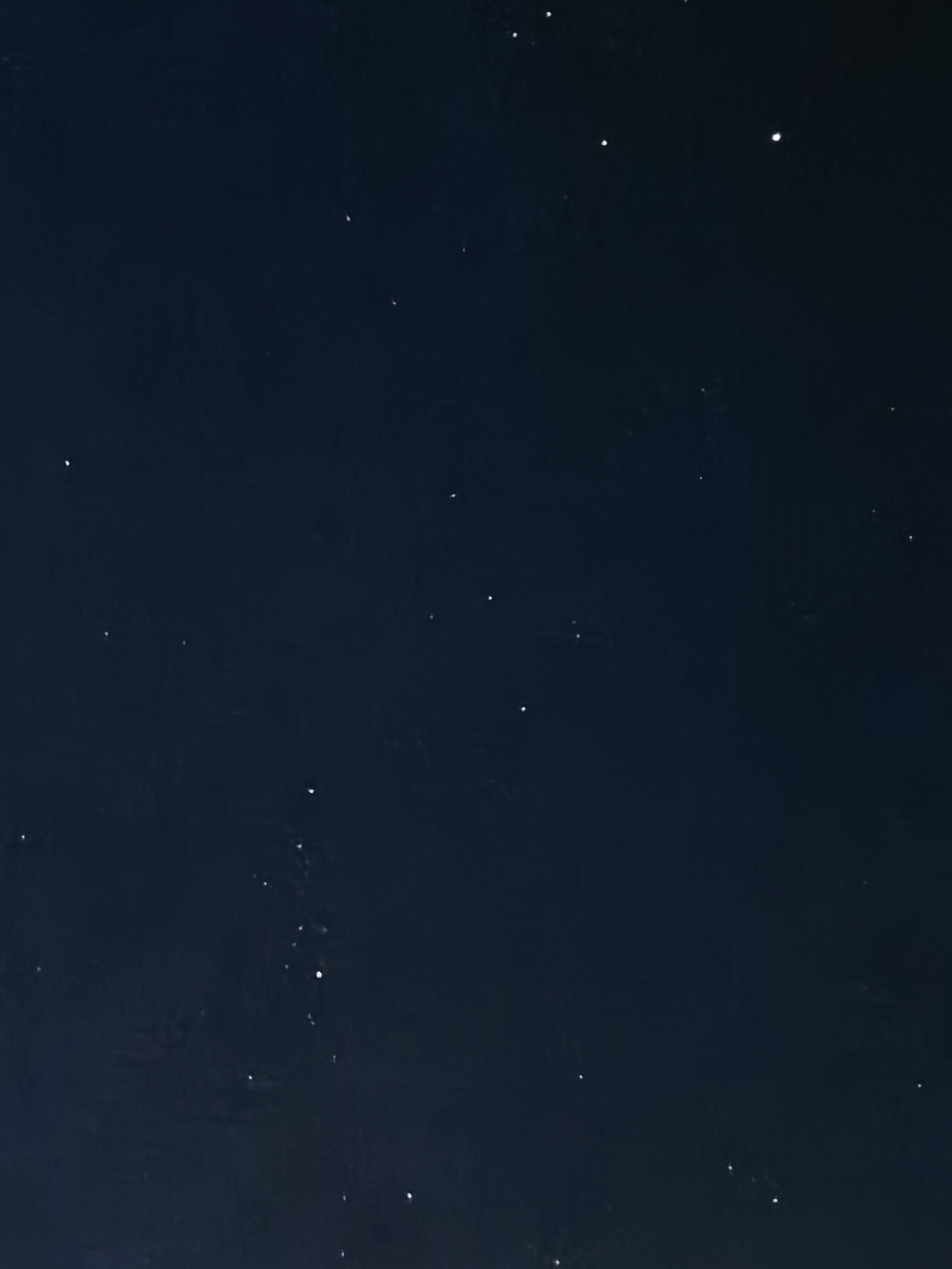 The image shows a dark night sky. Several stars are visible as small, bright points of light scattered across the dark background. The location appears to be in an area with relatively low light pollution, allowing for the visibility of these celestial bodies.