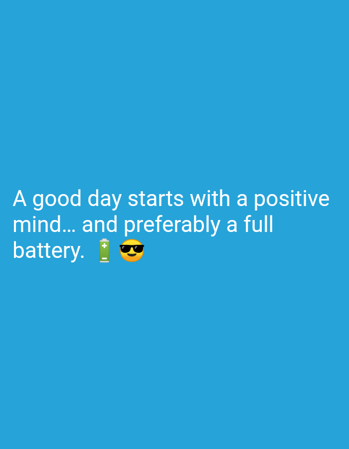 The image displays text on a blue background. The text reads "A good day starts with a positive mind... and preferably a full battery." Next to the word "battery," there is a battery emoji and a sunglasses emoji. There is no indication of a location in Karangsambung, Indonesia, nor are there any people, subjects, or actions depicted. The environment is simply a plain blue background.