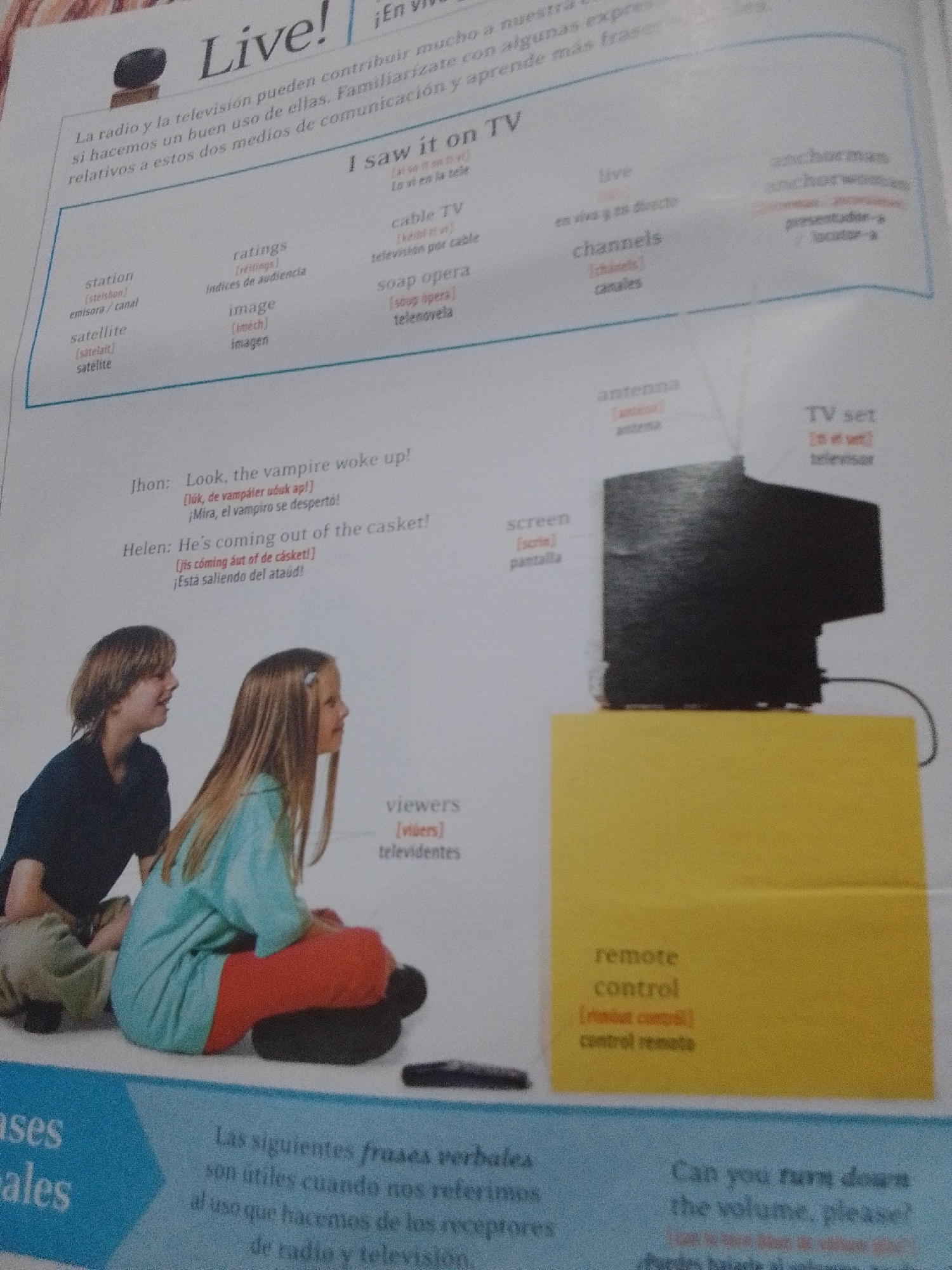 The image displays a page from a learning resource focused on television and radio vocabulary. The top section features the title "Live!" and the phrase "I saw it on TV," with accompanying vocabulary lists in English and Spanish. These lists include terms like "station," "satellite," "ratings," "image," "cable TV," "soap opera," "live," "channels," "antenna," "TV set," "screen," "viewers," "anchorman," and "anchorwoman." Below the vocabulary section, there is a short dialogue in English with Spanish translations, featuring two children, a boy and a girl, looking in the same direction. The dialogue is about a vampire waking up and coming out of a casket. In the background, a vintage television set is visible on a yellow stand, with a remote control in the foreground. The bottom section of the page has a blue background with text in Spanish, discussing useful phrases related to radio and television. There is no information or context within the image that would suggest a location in La Tagua, Venezuela.