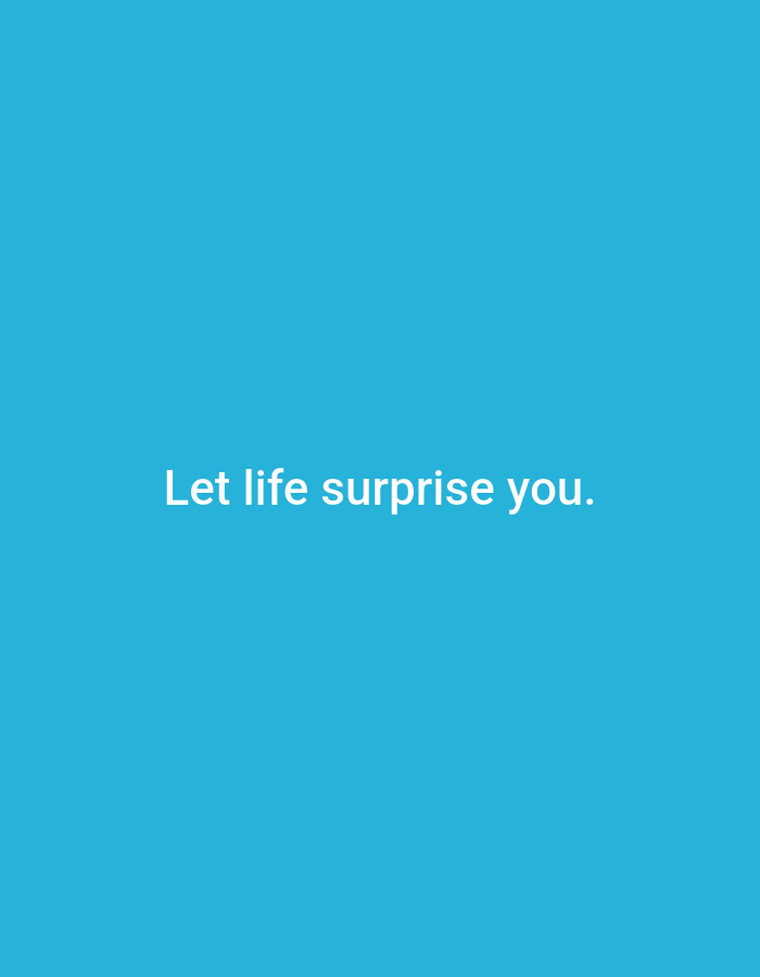 The image displays a solid, bright blue background. Centered horizontally and in the lower third of the image, the text "Let life surprise you." is rendered in a white, sans-serif font. There are no people, objects, or discernible environmental features present in the image other than the text and the blue background. The location in Ramraj, India is not discernible from the visual information provided.