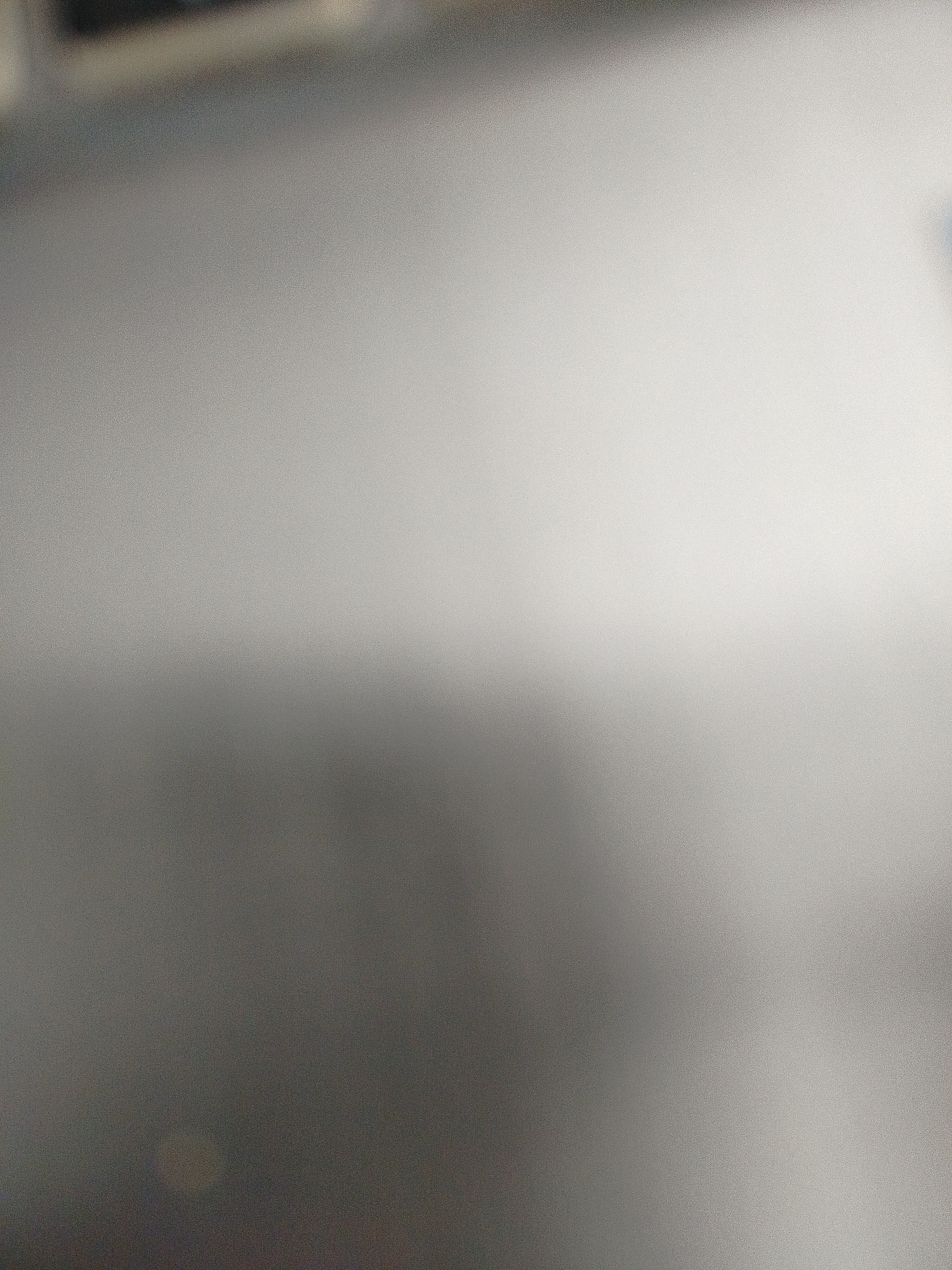 The image shows a blurry, out-of-focus gradient of gray and white. There are no identifiable objects, subjects, people, actions, or interactions visible. There is not enough information to determine the location in Yerevan, Armenia.