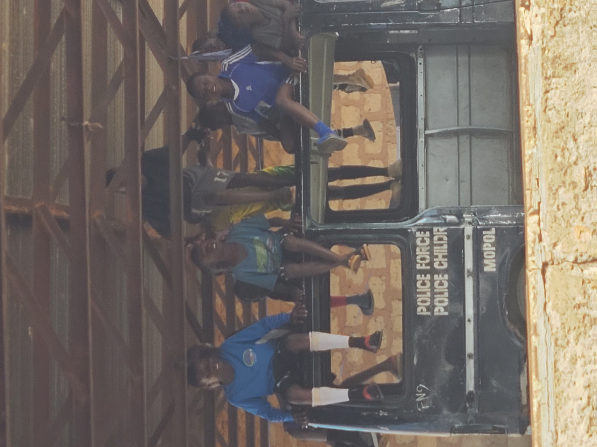 Children are riding inside a MOPOL police vehicle in Jos, Nigeria.