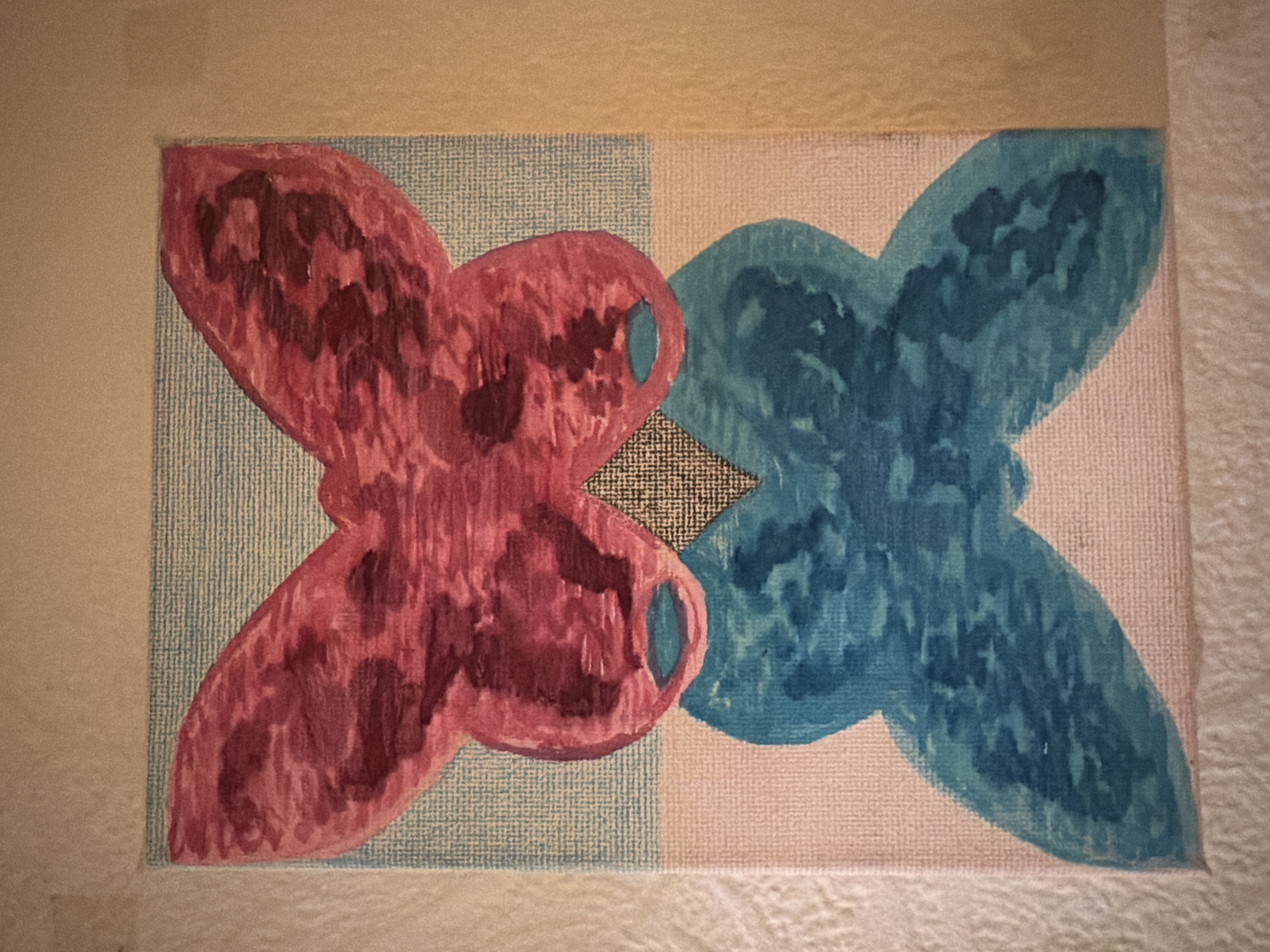 The image is of an amateur painting. The painting depicts two abstract shapes, one primarily red and the other blue, overlapping slightly in the center. The background behind the red shape is blue with a light vertical striped pattern, while the background behind the blue shape is off-white, also with a light vertical striped pattern. A small diamond shape with a dark crosshatch pattern is placed where the two colored shapes overlap. The painting is framed with a light beige border. The painting is not located in London.