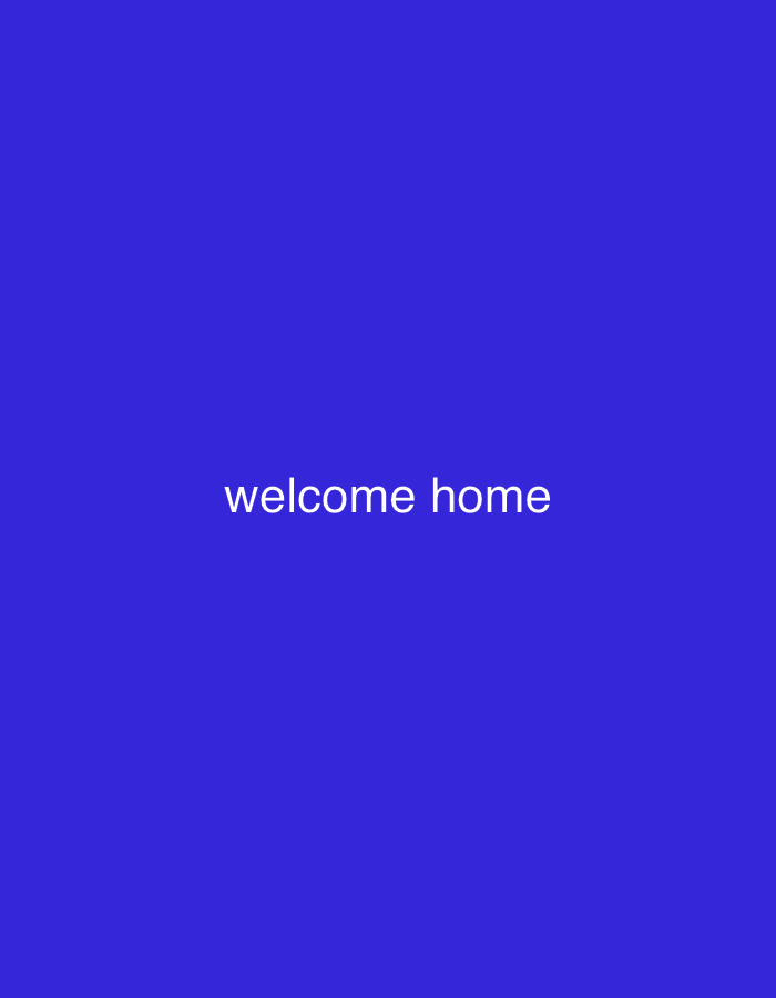 The image displays white text that reads "welcome home" centered on a solid royal blue background. There are no people, objects, or environmental details present in the image, as it is solely a text-based graphic. It does not depict any specific location in Lhokseumawe, Indonesia, or any other geographical area.