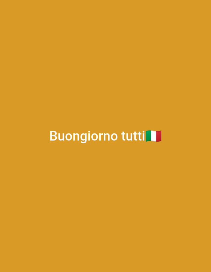 The image shows white text that reads "Buongiorno tutti" which translates to "Good morning everyone" in Italian. To the right of the text is a small Italian flag emoji. The background is a solid, warm orange color. The image does not depict any specific location in Bitonto, Italy, nor does it contain any people, objects, or actions. It is a graphic with text and an emoji on a plain background.