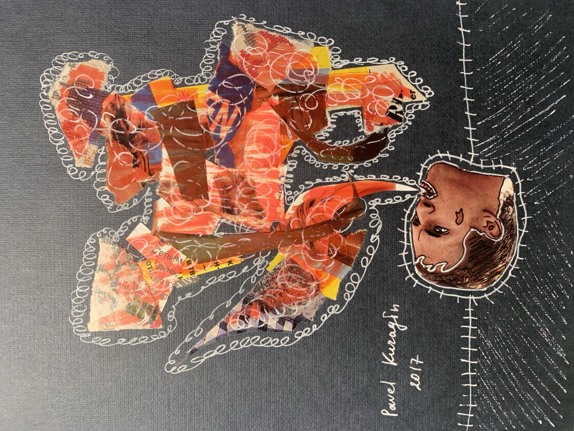 This is a piece of artwork, a collage with painted elements on a dark gray textured paper. The artwork features a collage of torn paper scraps, primarily in red, orange, and blue hues, arranged in an abstract, cloud-like shape at the top center of the composition. White lines, resembling stitching or scribbles, are drawn around and within the collage elements, outlining them and creating a decorative border. Below this abstract shape, a human face is depicted in profile, facing upwards. The face appears to be coming out of a stylized, oval frame outlined with white stitching. The mouth of the face is open and appears to be exhaling or emitting the collage from above. The skin tone of the face is brown, with dark brown hair. White lines also form a stitched pattern below the face, with some diagonal lines suggesting texture or shadow. In the bottom left corner, handwritten text reads "Pavel Kuragin" and below that, "2017". There is no information about the city of Sergeevo, Russia, within the image itself or its immediate context.