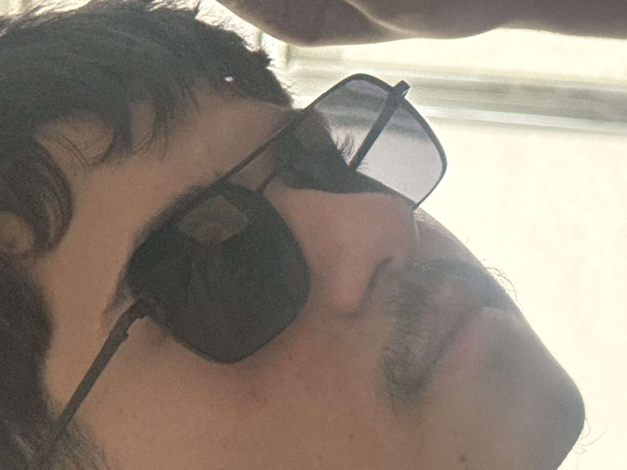 A close-up, angled view of a person's face and head wearing sunglasses. The person has dark hair and a mustache. The background is out of focus and appears to be a bright, possibly outdoor, setting. There is no verifiable information in the image to connect it to the city of Varna, Bulgaria.