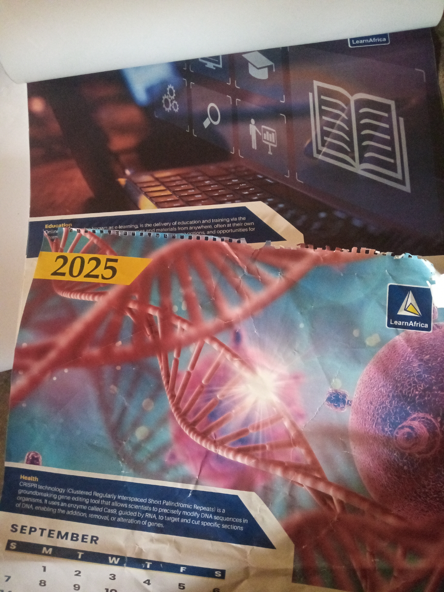 The image shows a calendar page for September 2025 with a DNA helix graphic. The calendar is part of a larger calendar that features a digital learning theme with icons of a laptop, graduation cap, and book. The "LearnAfrica" logo is visible on both the top and bottom right corners of the calendar. The bottom portion of the calendar includes a section on "Health" explaining CRISPR technology. The image is a close-up of the calendar and does not depict any specific city or location in Jalingo, Nigeria.