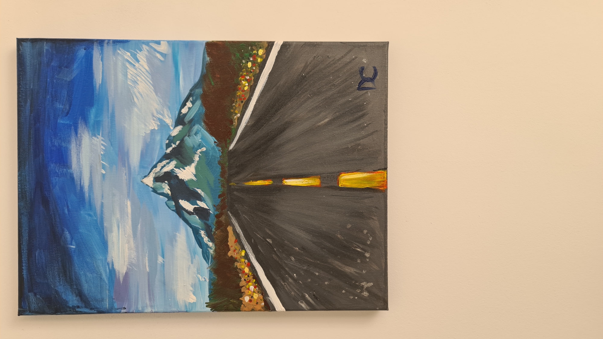 The image displays a painted landscape, rotated 90 degrees counter-clockwise. The painting depicts a scenic coastal road winding through mountainous terrain alongside a body of water under a bright sky.
**Subjects:** The central subject is a dark grey road with distinct yellow center markings that recede into the distance, flanked by a solid white line on its left edge. To the immediate left of the road is a dark brown landmass, possibly a cliff or mountain base, with patches of green foliage and white highlights. Beyond this landmass, a large expanse of blue water, likely the sea or ocean, is visible, rendered with varying shades of blue and white brushstrokes suggesting waves or light reflections. Above the water, a lighter blue sky with white, cloud-like brushstrokes completes the vista.
**Activity or event:** No specific activity or event involving people is depicted; it is a static landscape scene. The composition evokes the feeling of a journey or travel along the scenic road.
**Notable details:** The painting employs an impressionistic style with visible, dynamic brushstrokes, particularly in the water and sky, conveying movement and light. The color palette suggests a daytime setting with clear or partly cloudy weather. The combination of a coastal road, mountains, and sea is highly indicative of the Budva, Montenegro region, known for its dramatic Adriatic coastline and mountainous landscapes. In the upper right corner of the canvas (when viewed in correct orientation), a dark blue, stylized initial, resembling an "R" or "Я", is visible, likely the artist's signature. The overall mood is one of natural beauty and tranquility.